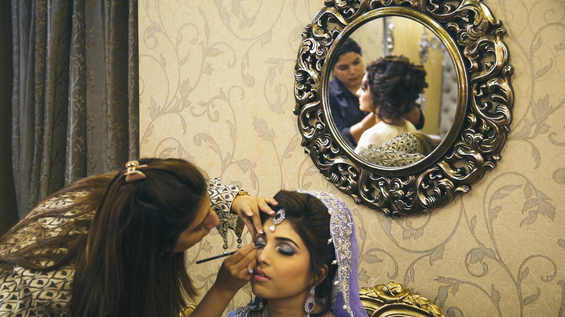  Newlyweds Ayesha and Farheen have their makeup done in advance of Sadaf's final wedding ceremony, the  baraat . Even though this ceremony is for Sadaf, tradition dictates that new brides dress nicely for a month after their wedding. All three brides