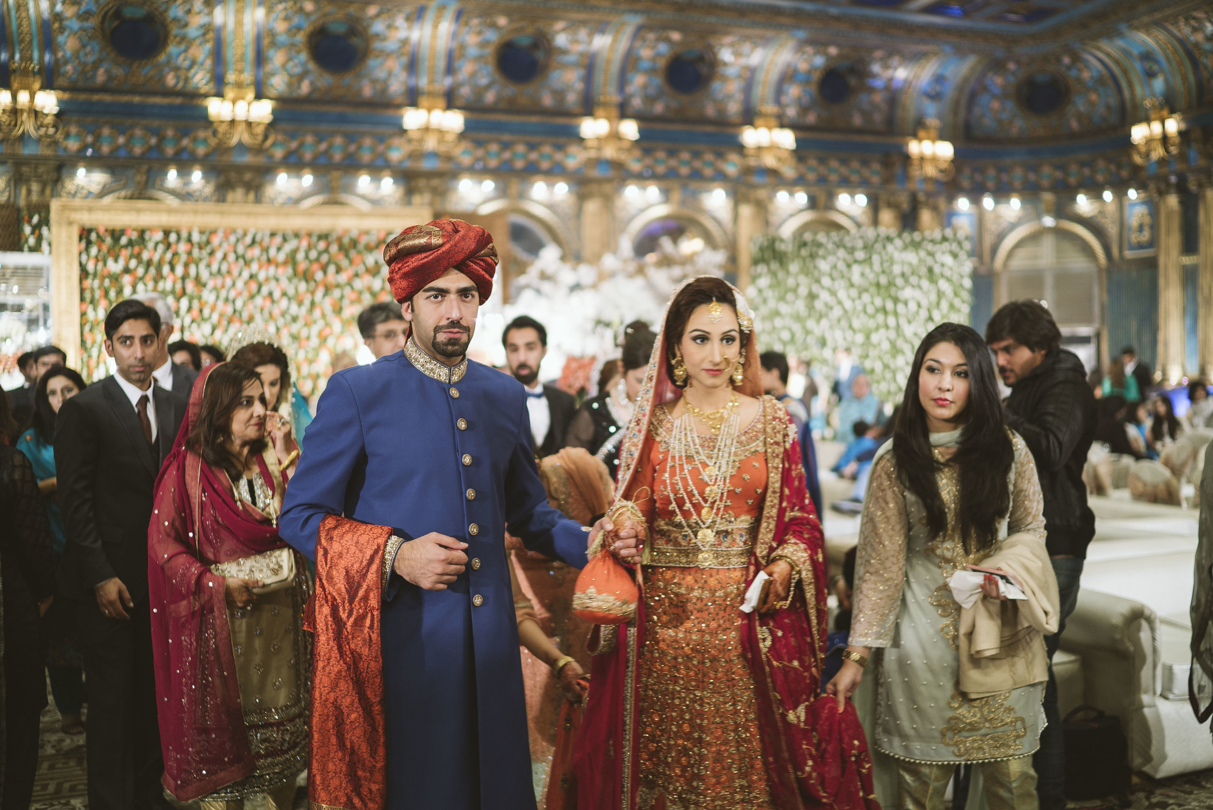  Kashif Malik escorts his new wife Sadaf out of the wedding venue on the day of their  baraat . She is about to head to his family's home and spend the night there for the first time. 