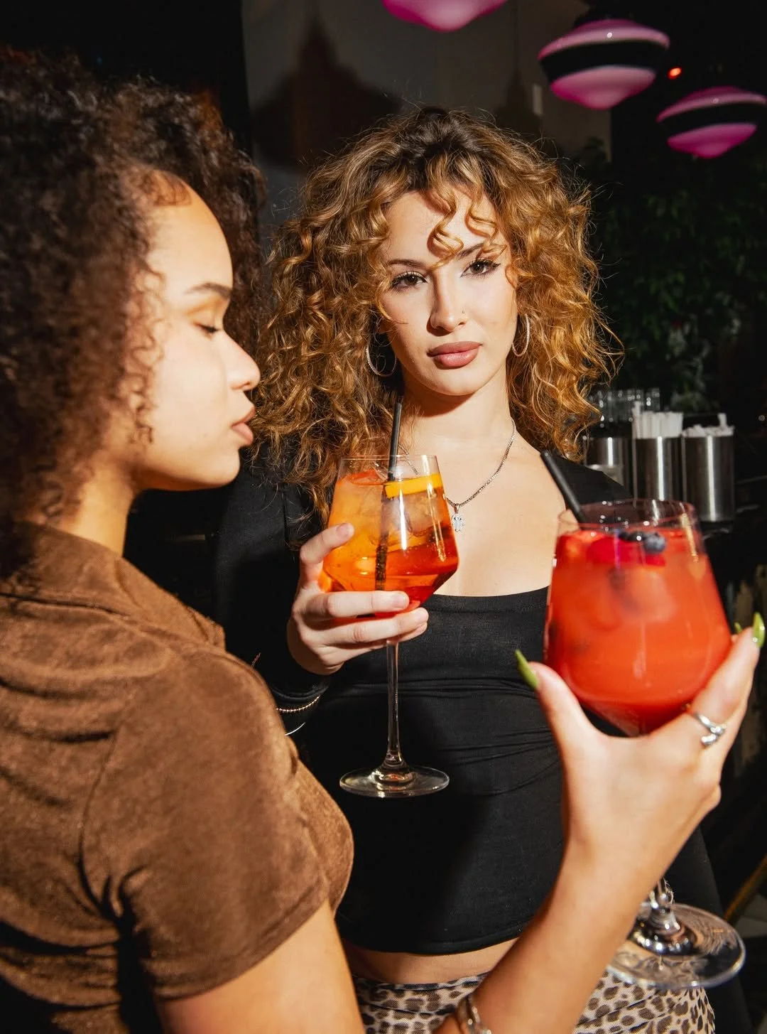Women enjoying cocktails together at Fox on John