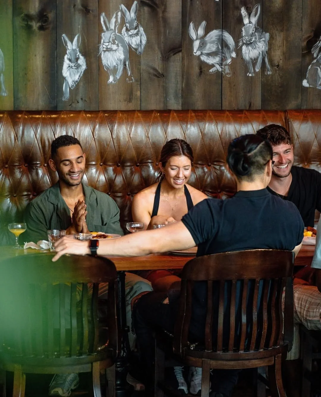 Guests enjoying large group dining at Fox on John in downtown Toronto.
