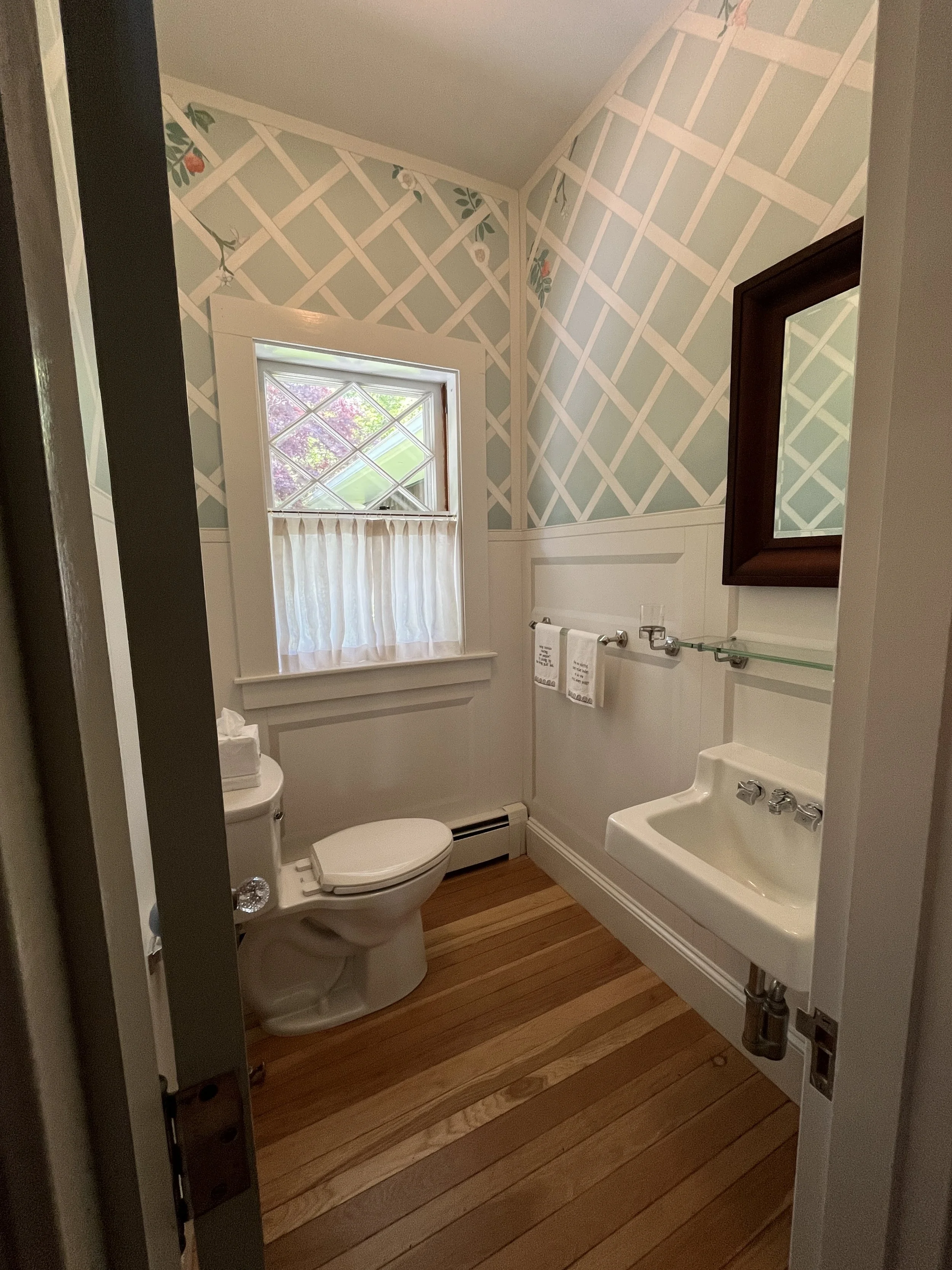 Trompe l'oeil Powder Room • Faux paneling, latticework, and plant life. 