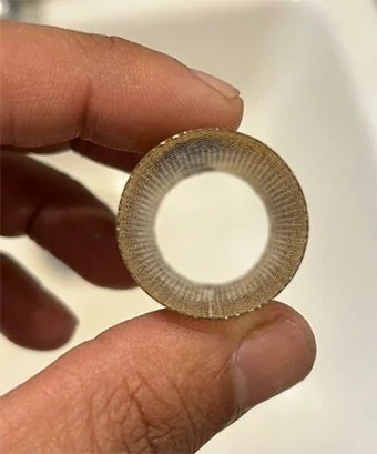 Heating engineer holding a cleaned HIU strainer