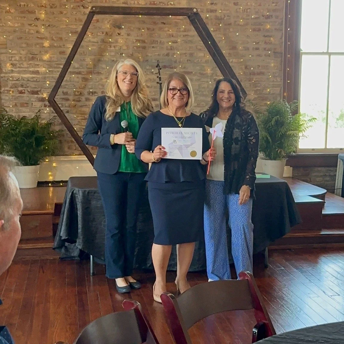 Leslie Deen & Cammy Jackson with Liz Calvo receiving a Pinwheel Certificate on behalf of Perdue LLP