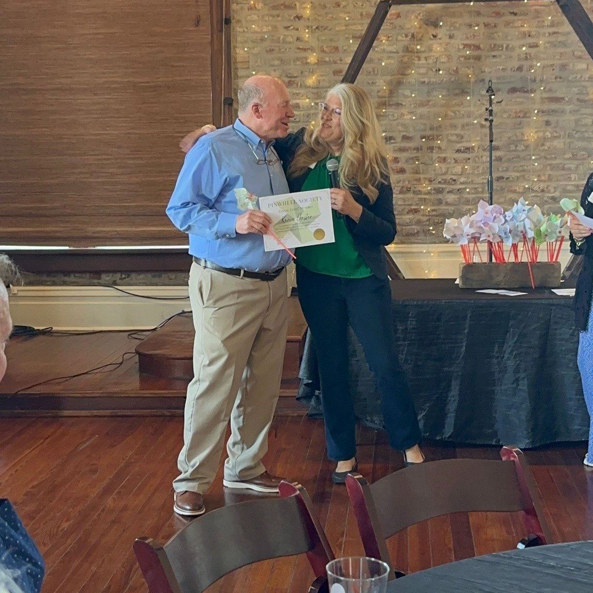 Kevin Chester receiving his Pinwheel Certificate from Leslie Deen