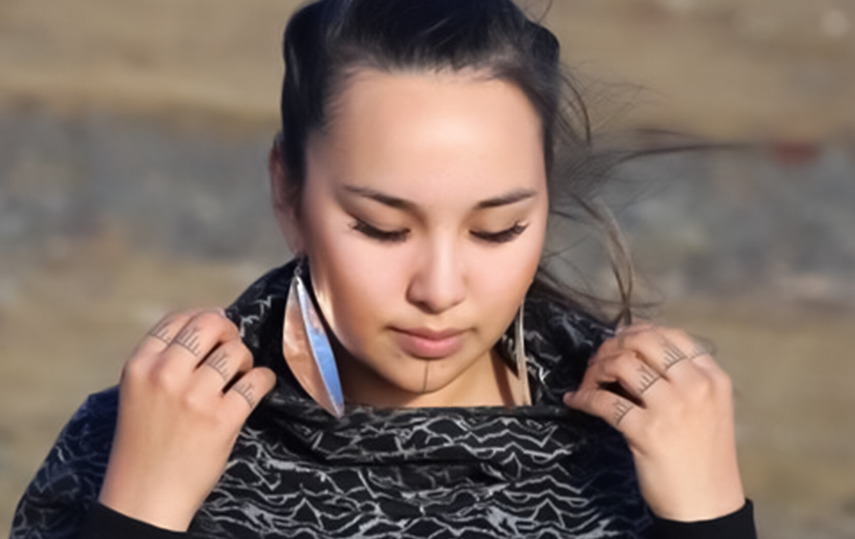   Mathew Nuqingaq  , Nathalia Okalik Wearing Quilliq Earrings , 2019. Silver, 10 x 3 cm. COURTESY OF THE ARTIST 