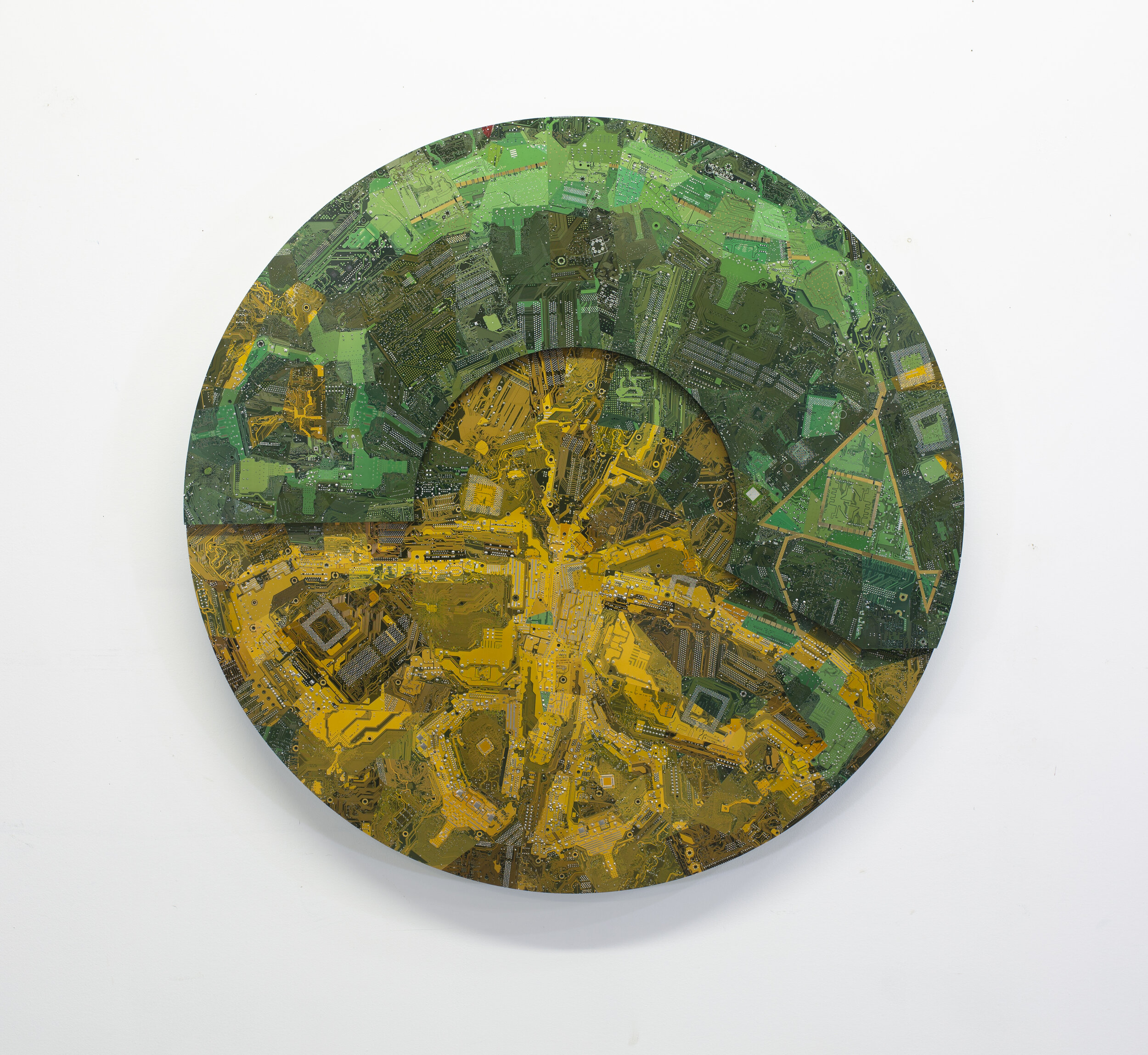   Caterpillar, Egg, Cocoon, Moth , 2019. Circuit boards on plywood, and nails, 87 cm diameter. COURTESY OF KT KANAZAWICH 