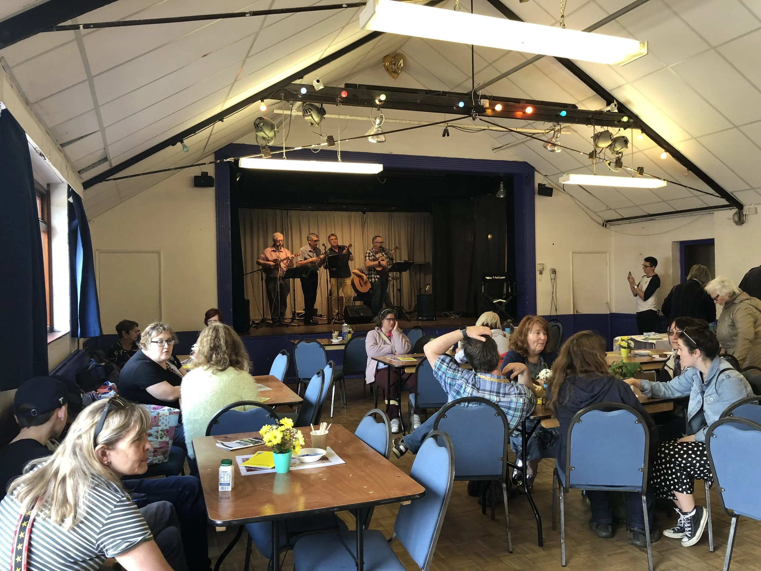 Seven Ukes playing in the hall.jpeg
