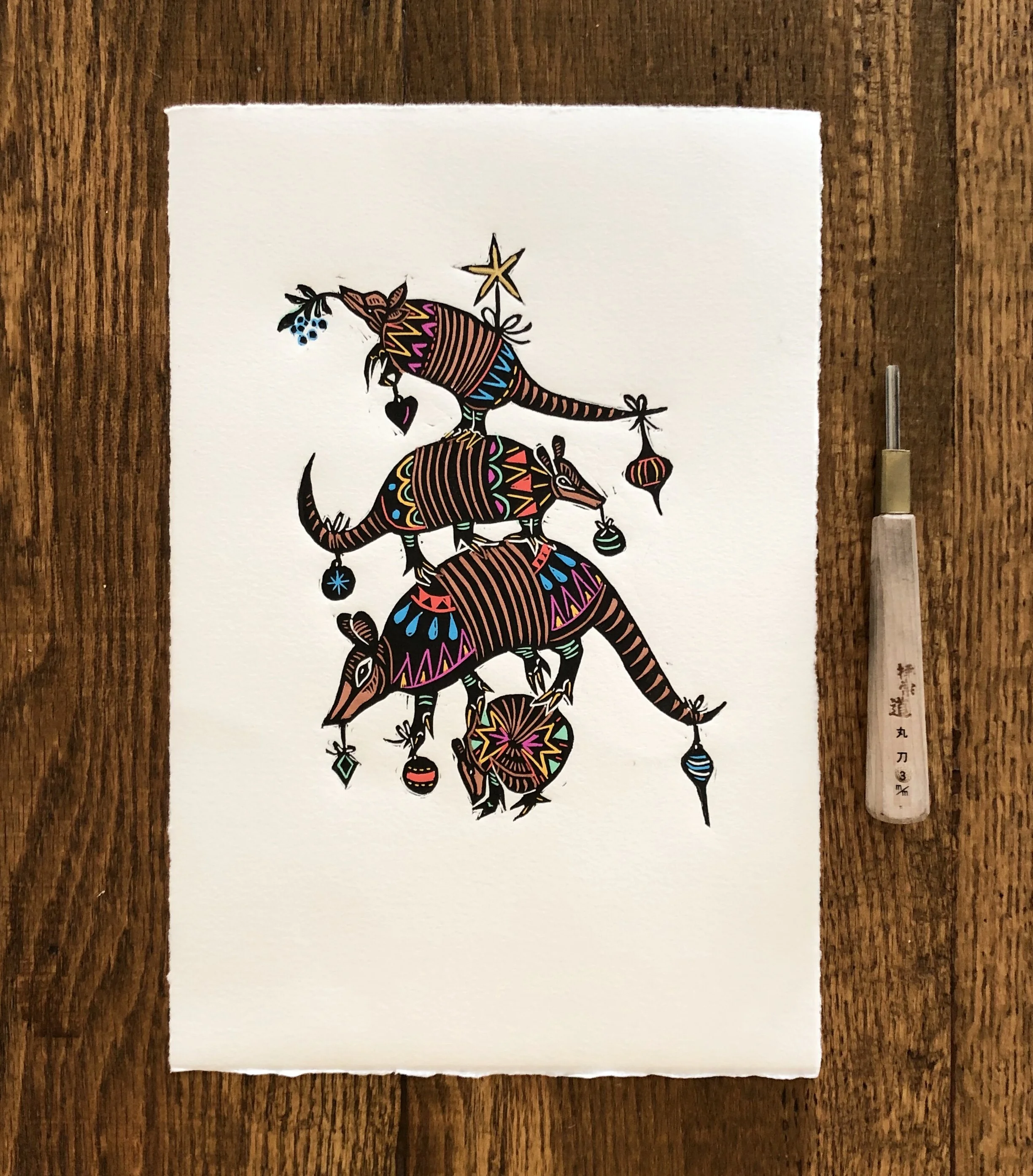 Aggressively festive armadillos hand colored block print