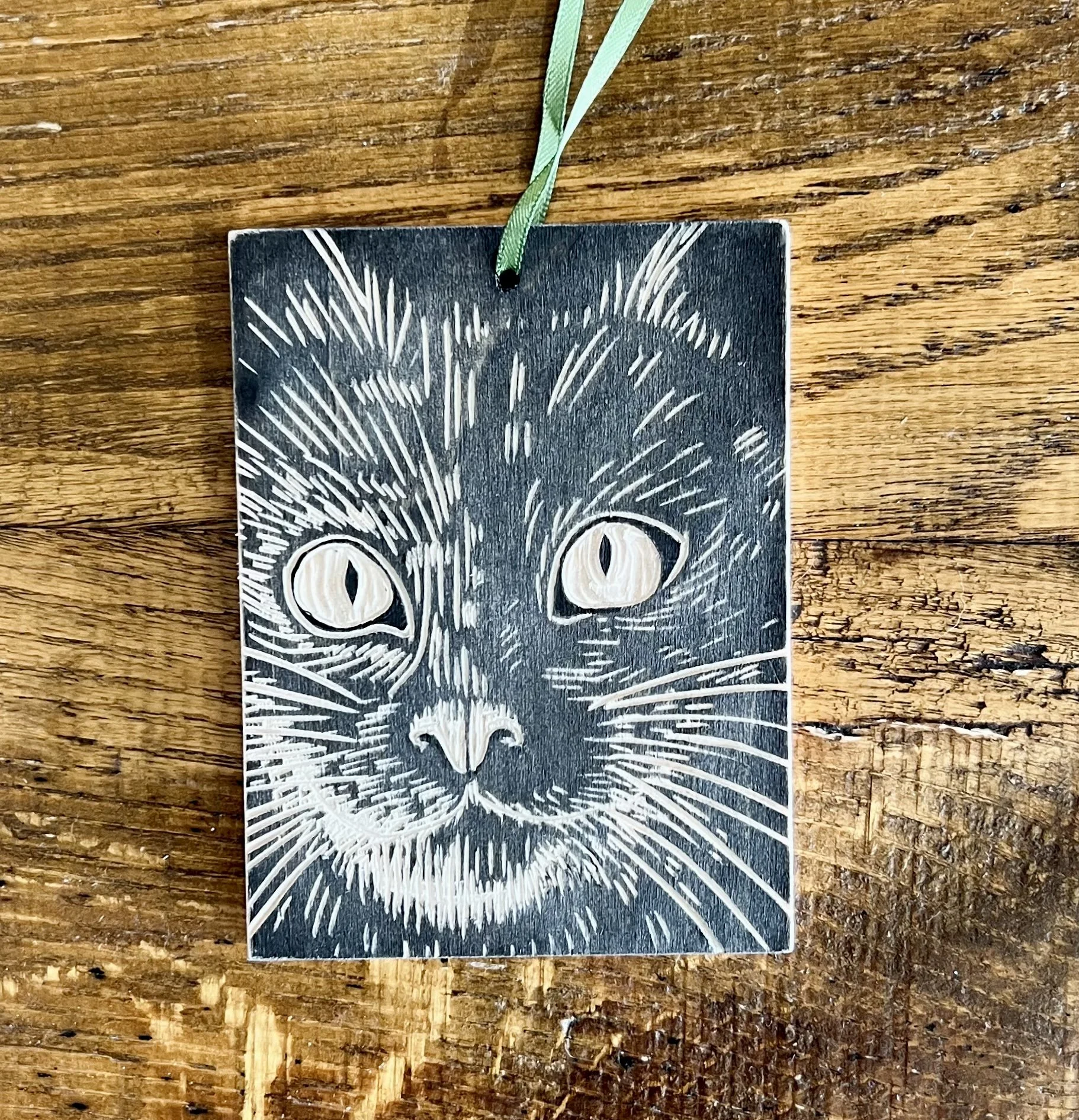 Kitty face woodcut ornament