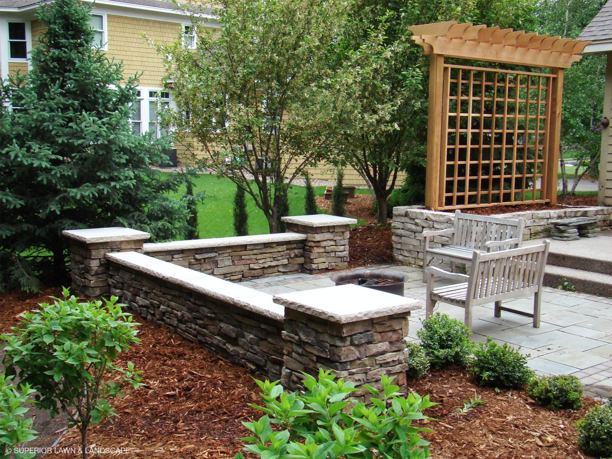 superior-lawn-landscape-outdoor-living-005-stone-wall-sitting-patio.jpg