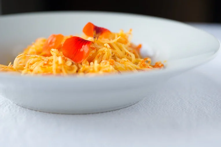 Calendula and nasturtium pesto with raw noodles. Photography: Dawn Langley. From a forthcoming online programme about working with Edible Flowers.