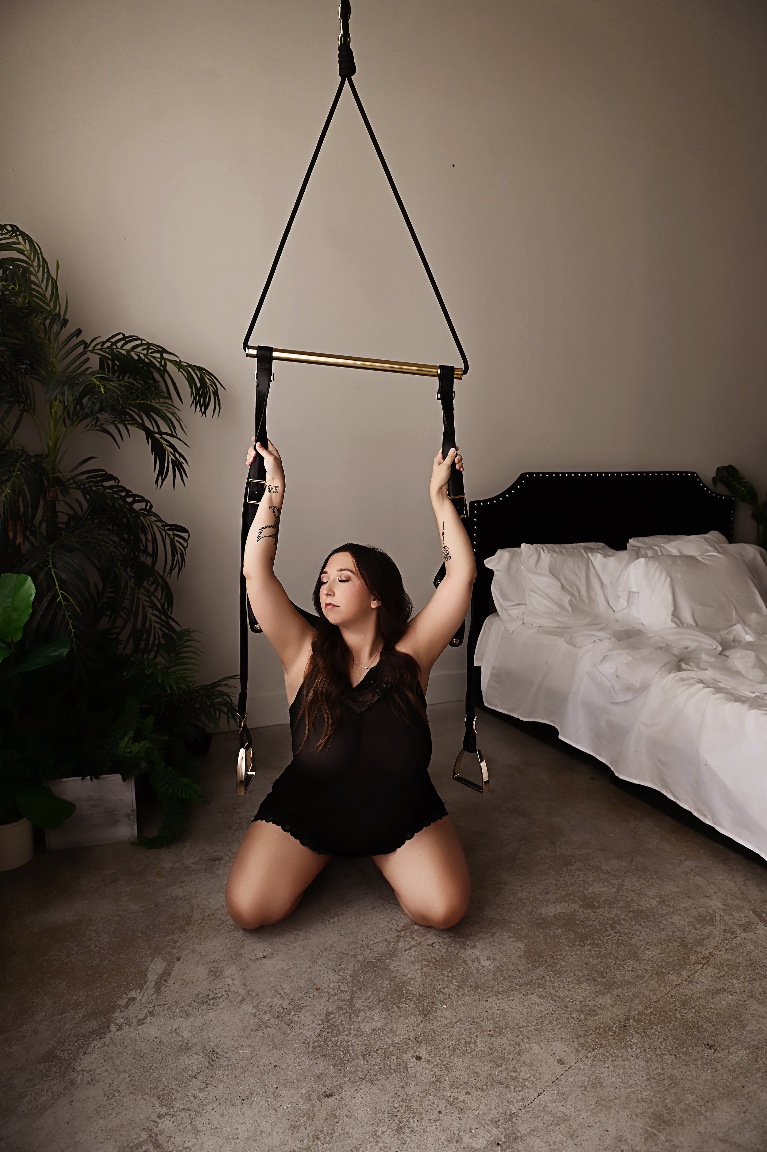 woman posing on floor with straps during boudoir session in louisiana Squarespace Description: Shreveport boudoir session using straps for guided posing creating a strong and confident look
