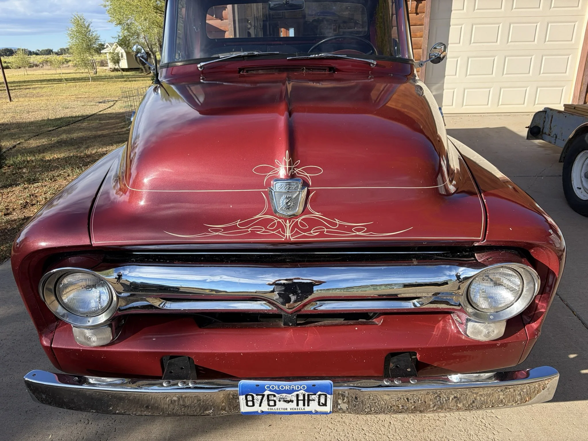 Maroon 1956 Ford F100 pickup with ivory pinstriping by Matt Beckner.