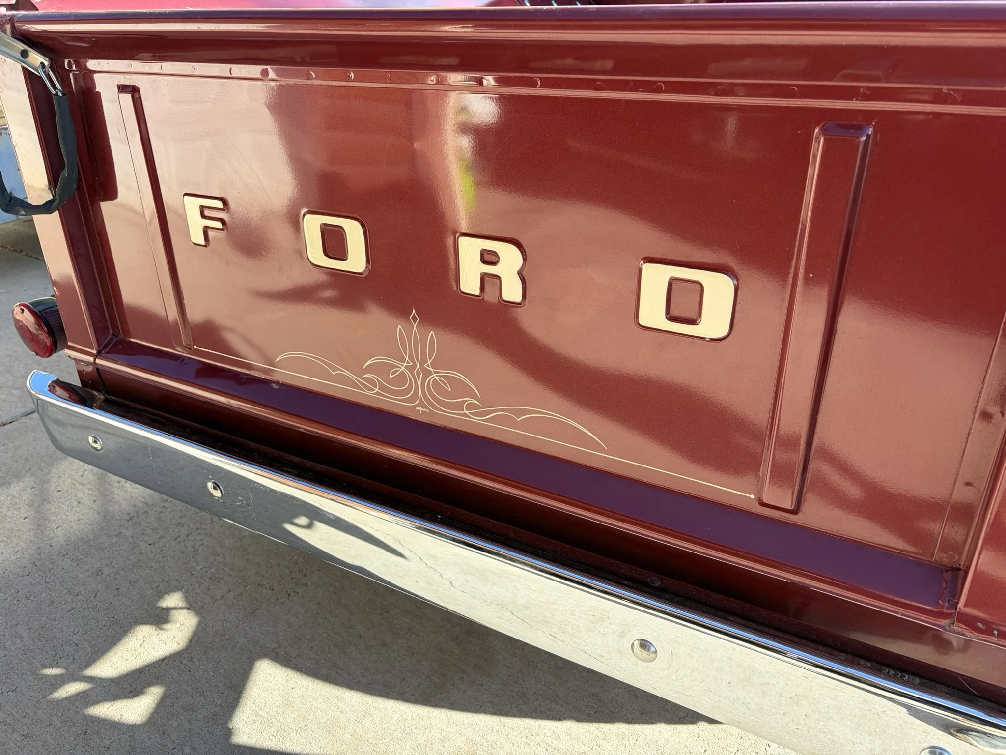 Maroon 1956 Ford F100 pickup with ivory pinstriping by Matt Beckner.