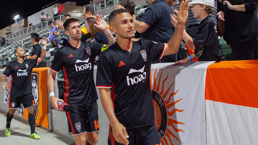 Orange County SC players high five fans after match | Photo courtesy of Orange County SC