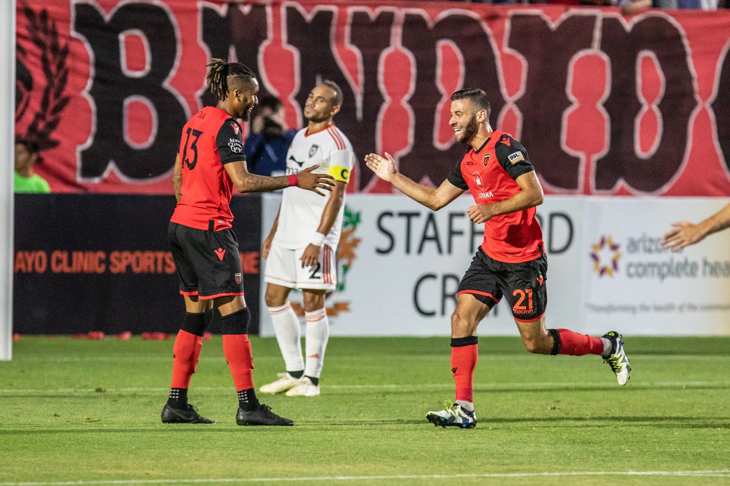 Orange County SC captain Kevin Alston looks on as Phoenix Rising FC’s Amadou Dia and Joey Calistri celebrate in OC’s 0-3 loss to Phoenix. | Photo courtesy of Michael Rincon/PHXRisingFC.com