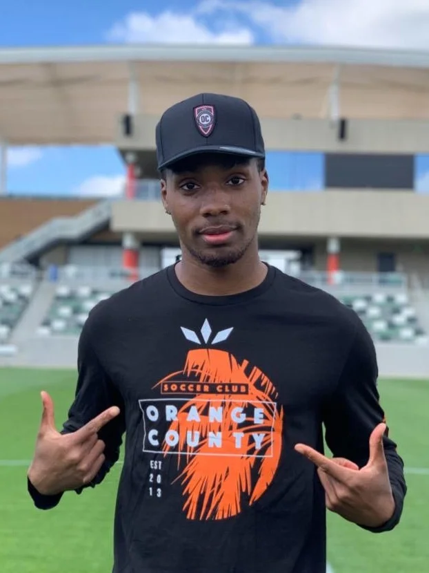 Orange County SC forward Michael Seaton shows off one of the shirts from the team’s Lifestyle Apparel brand. | Photo courtesy of Orange County SC