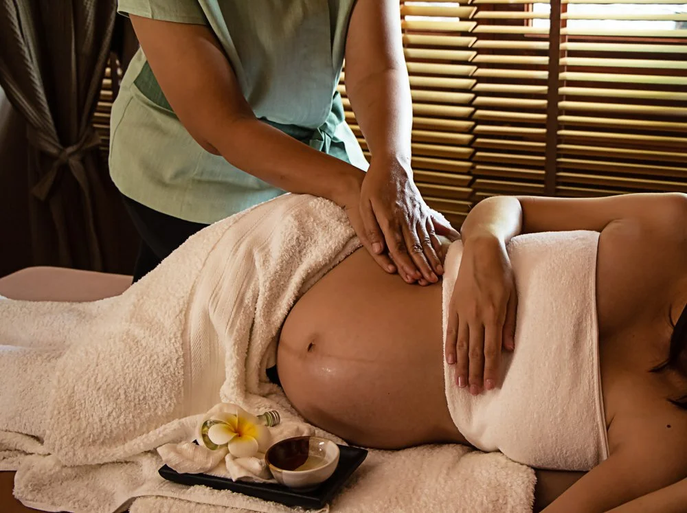 A woman recieving a prenatal massage.