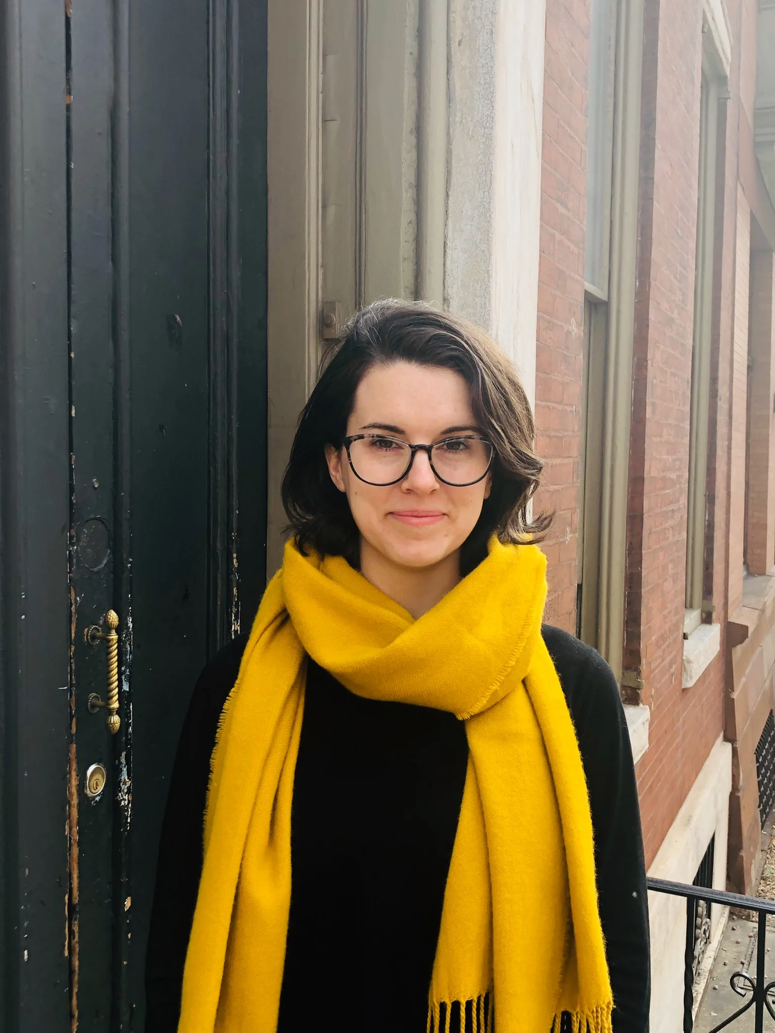 Embry Wood Owen, a white woman wearing glasses and a yellow scarf