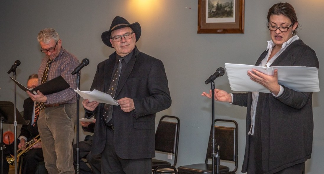 Tom Stock, Bob Gassmann, and Katie Drake, regulars in the noir detective series, as they appeared in the most recent of the Mac Blac plays, “Where’s the Brass Lantern?”
