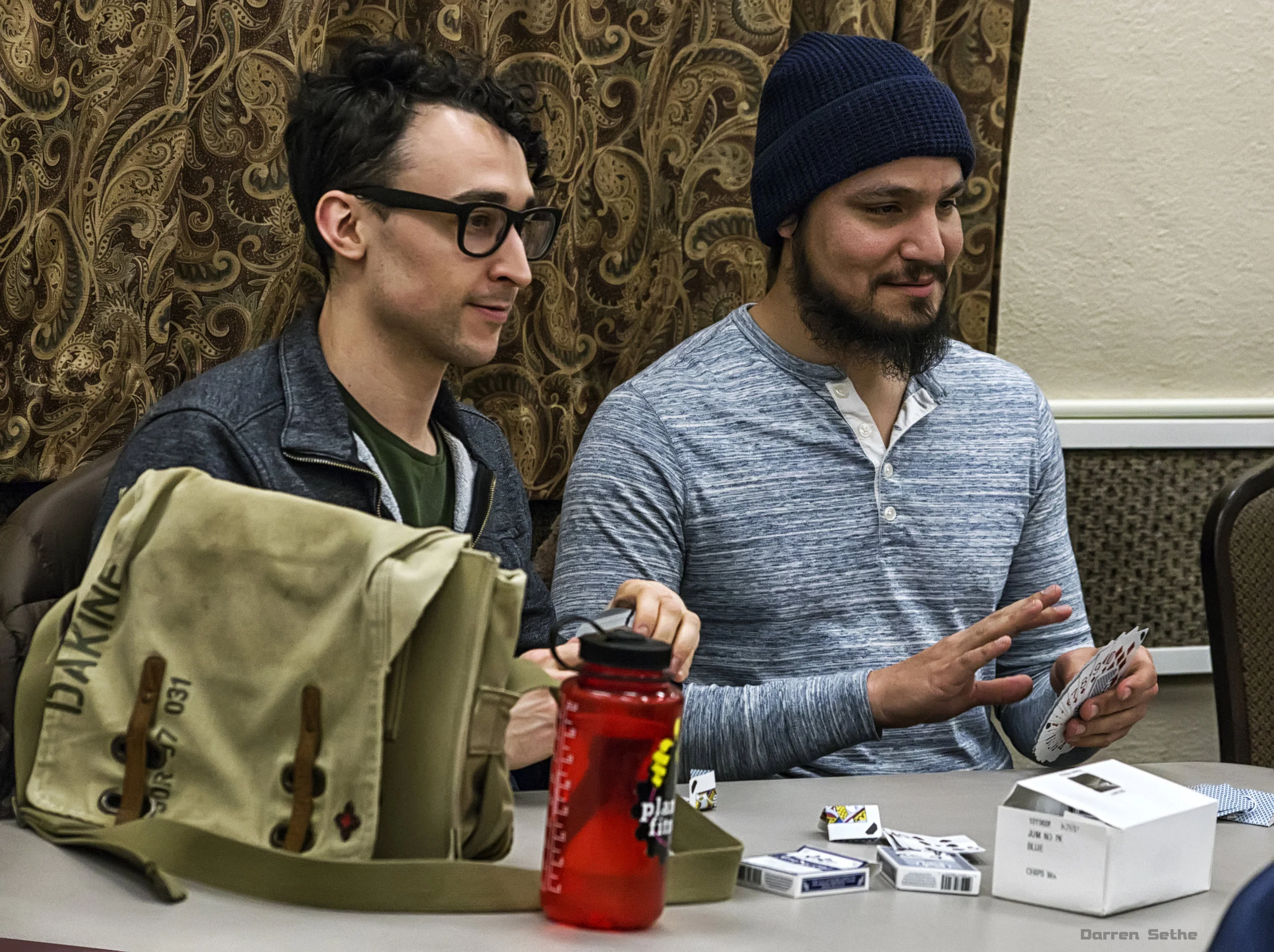 Frank Brislawn and Joseph Ruiz get free boxes of cards, and then decide to destroy everyone of them practicing their Mercury Card Folds (photo by Darren Sethe 2019)