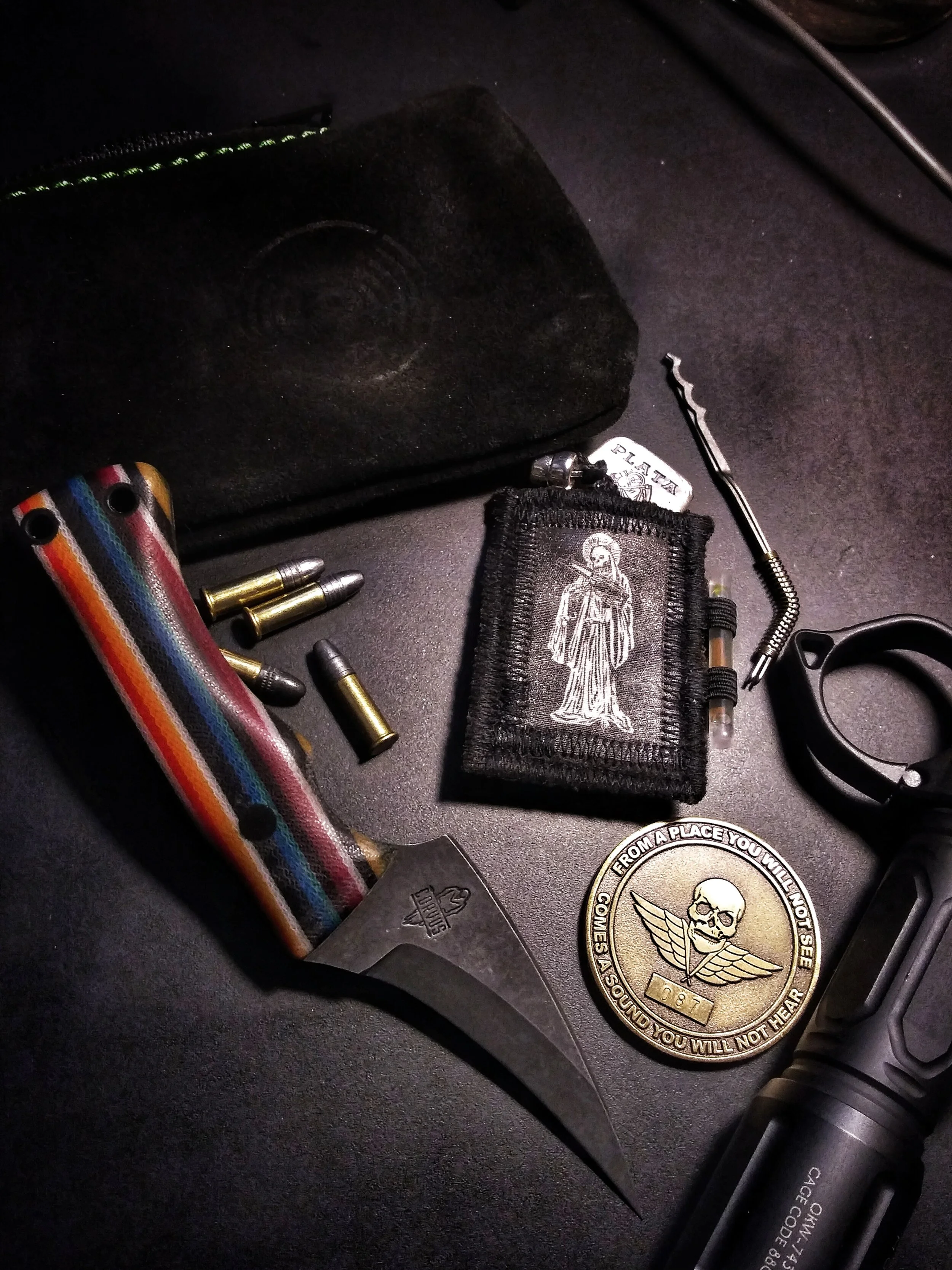 A knife laying amongst a pile of assorted items.