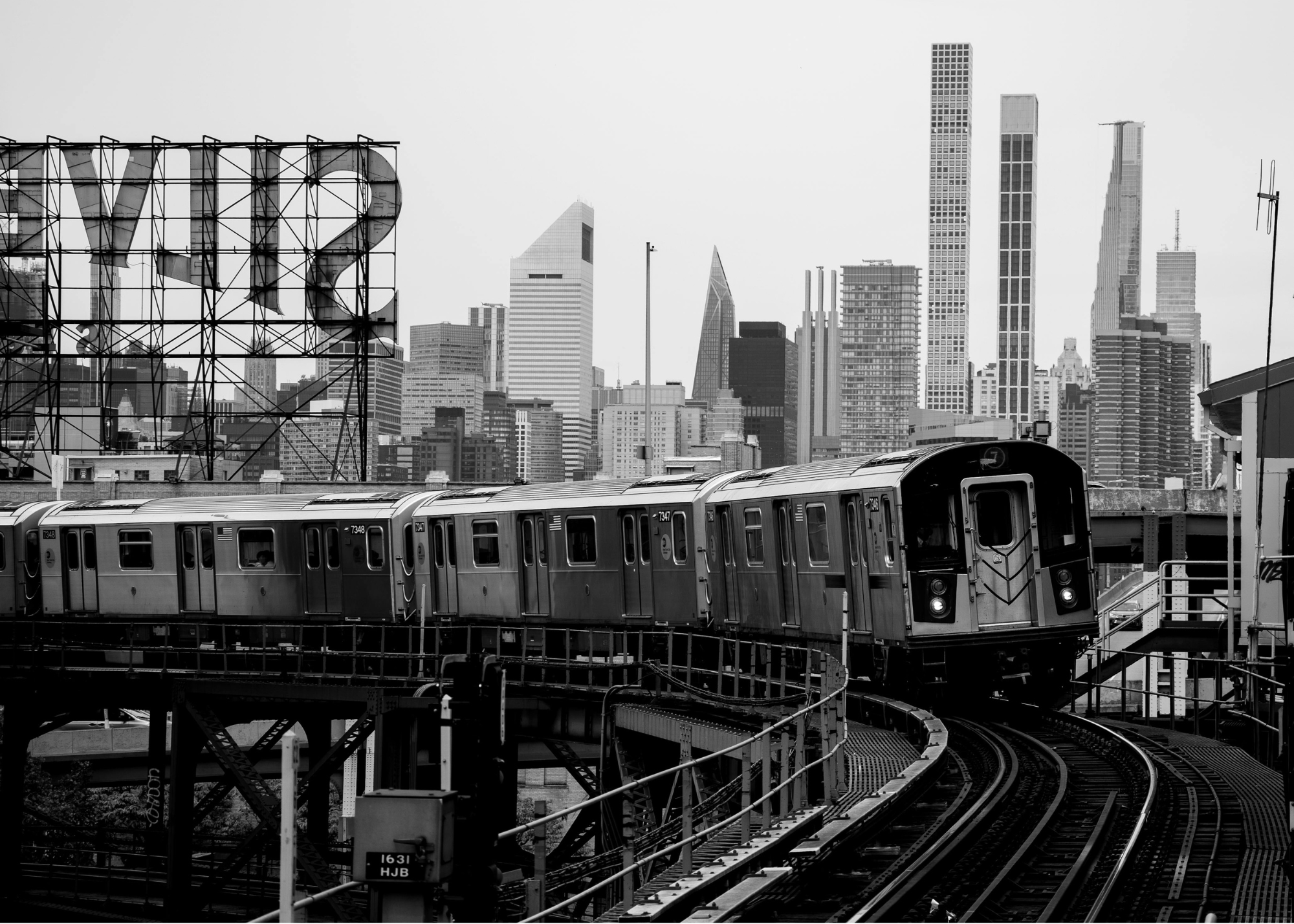 Black and white image of elevated subway car near Silvercup studios in Queens representing benefits of online therapy for women living with chronic pelvic pain in Manhattan, Queens, Brooklyn, Long Island, Westchester and Hudson Valley.