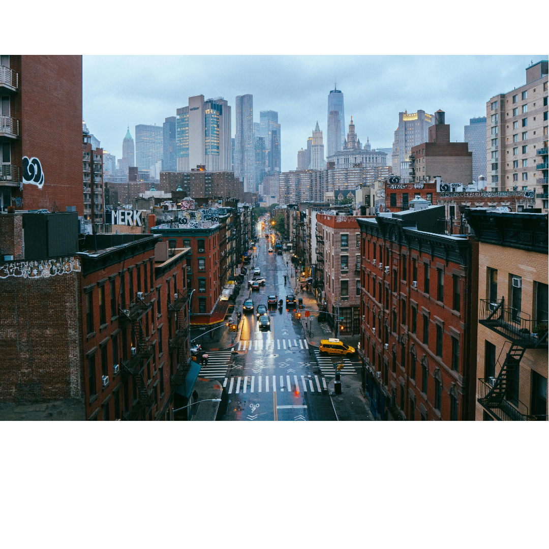 Image of historic buildings on New York City street with skyline in the background. Represents online therapy for women with endometriosis and chronic pelvic pain available throughout New York by licensed expert therapists.