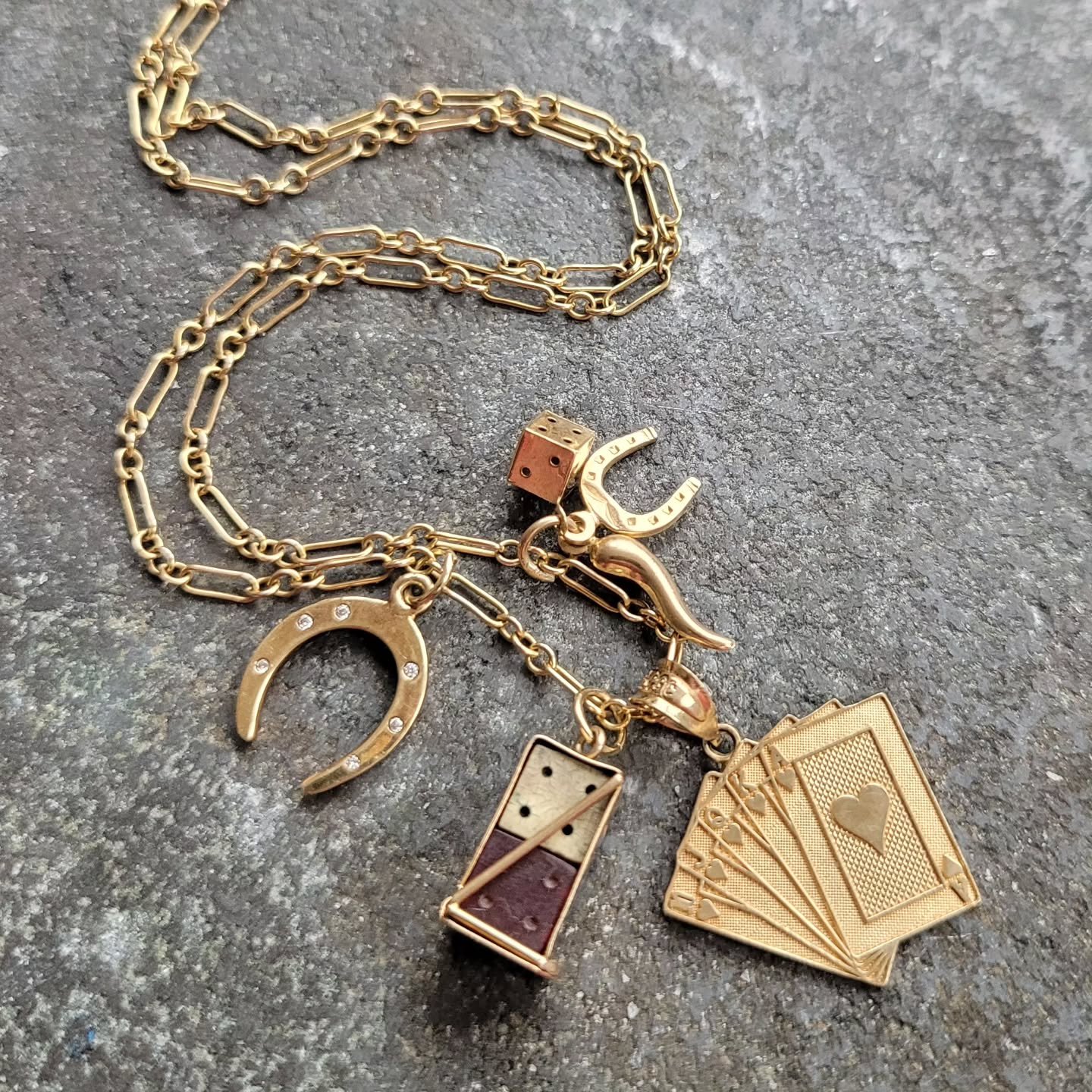 Four golden talismans, all created to bring you good luck. Roll the dice, flip your cards, or maybe you prefer a little diamond set horseshoe or cornicello to keep the bad juju away? All available including the chain, and all currently in the sale, b