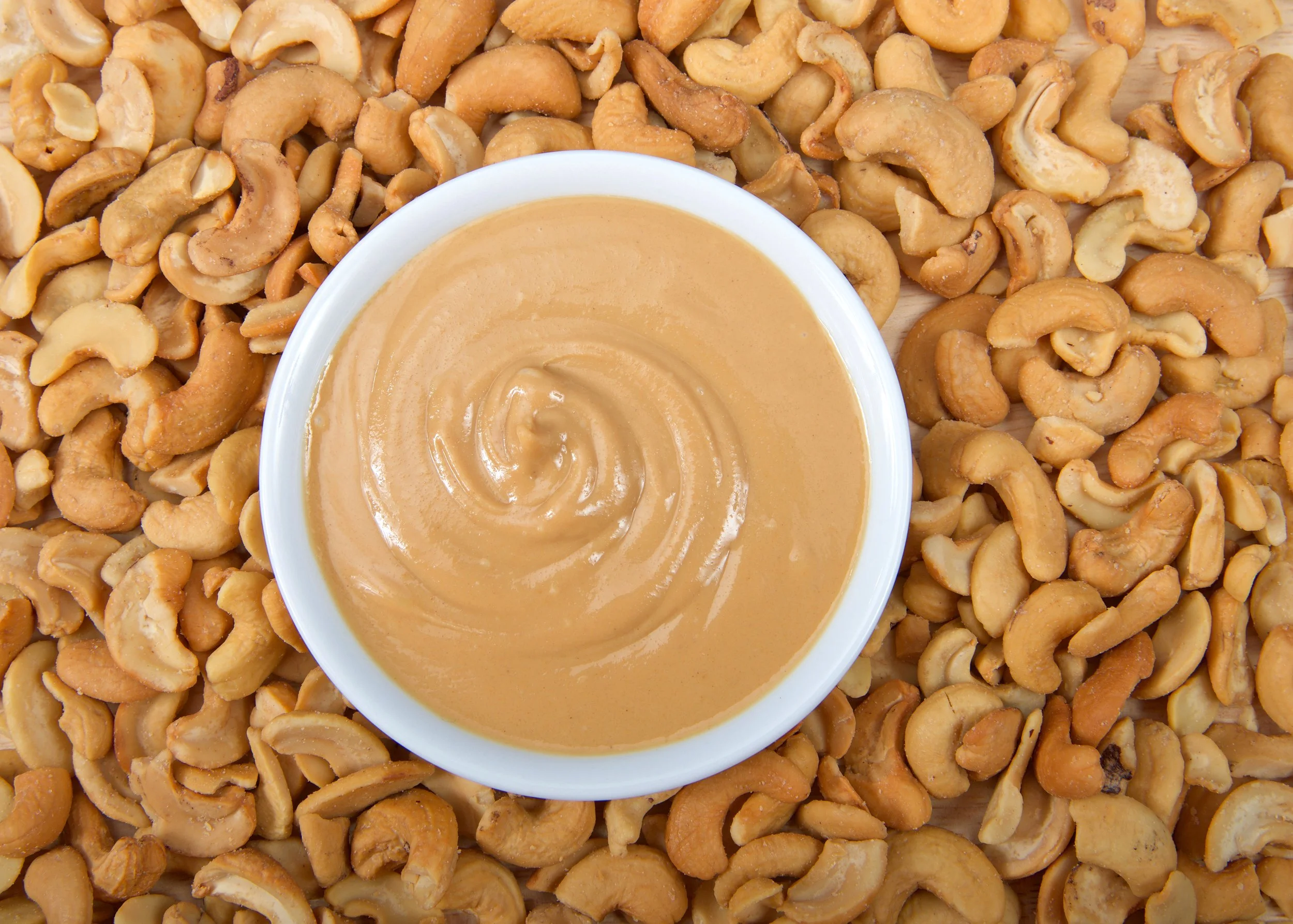 Cashew Butter in bowl on bed of cashews