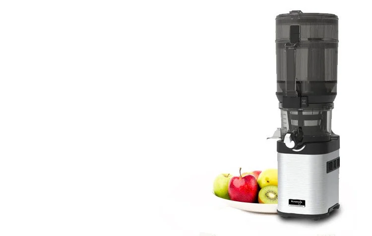 Kuvings CS800 next to a bowl of fresh fruit