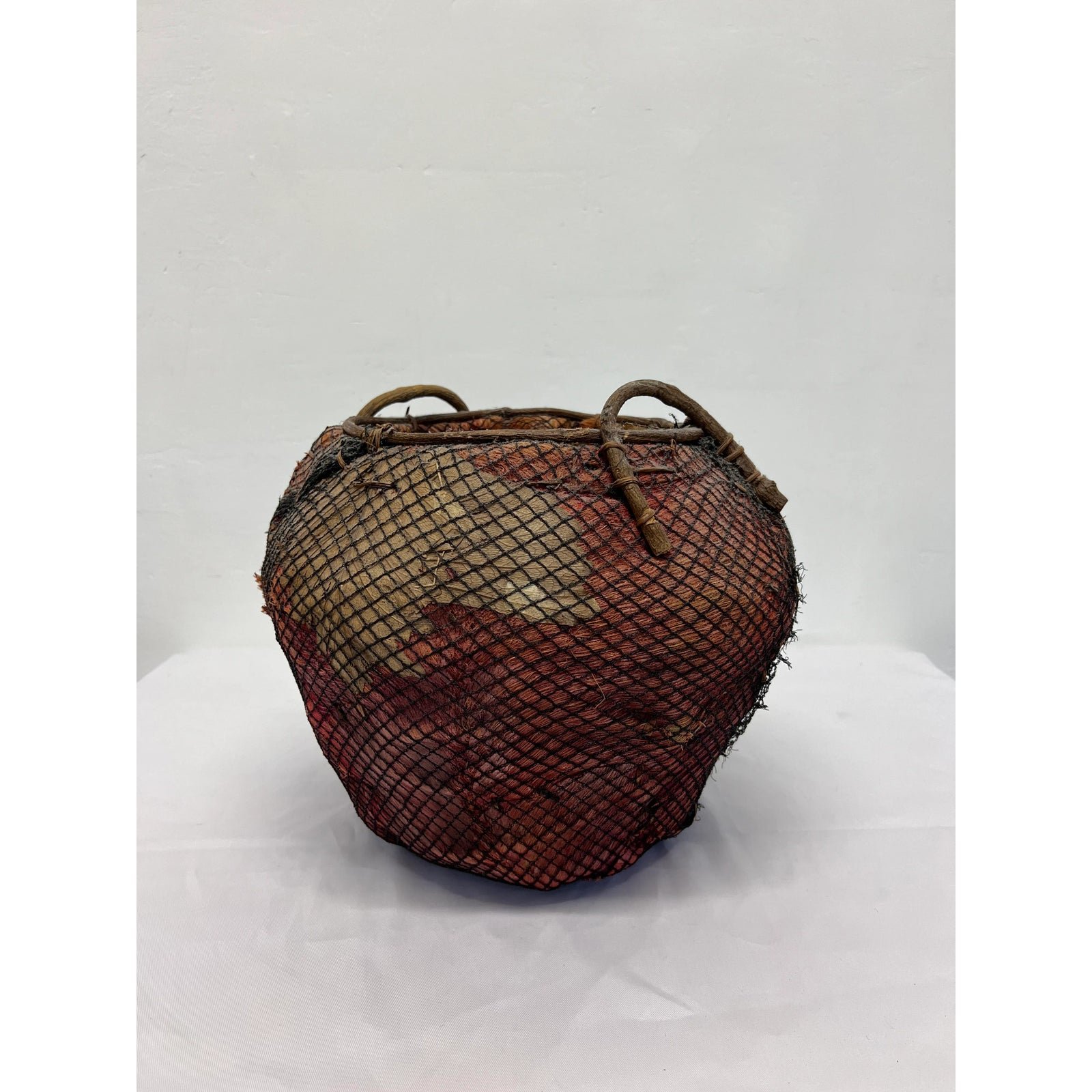 handmade-natural-fiber-and-leaf-basket-wrapped-in-fish-net-1970s-8441