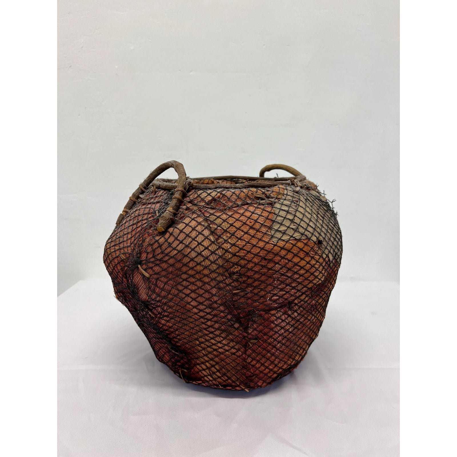 handmade-natural-fiber-and-leaf-basket-wrapped-in-fish-net-1970s-3027