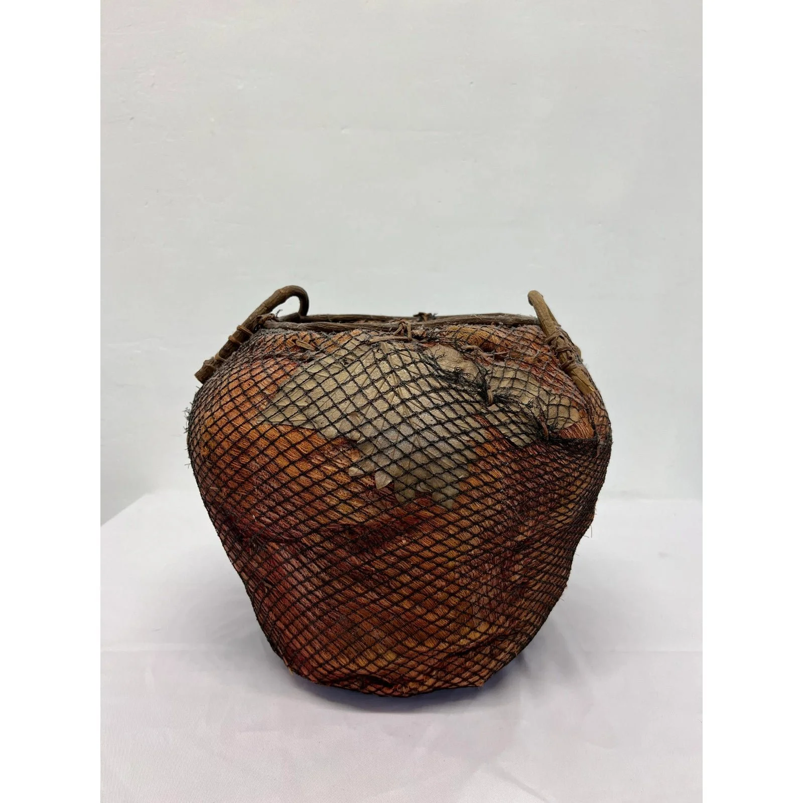 handmade-natural-fiber-and-leaf-basket-wrapped-in-fish-net-1970s-1684