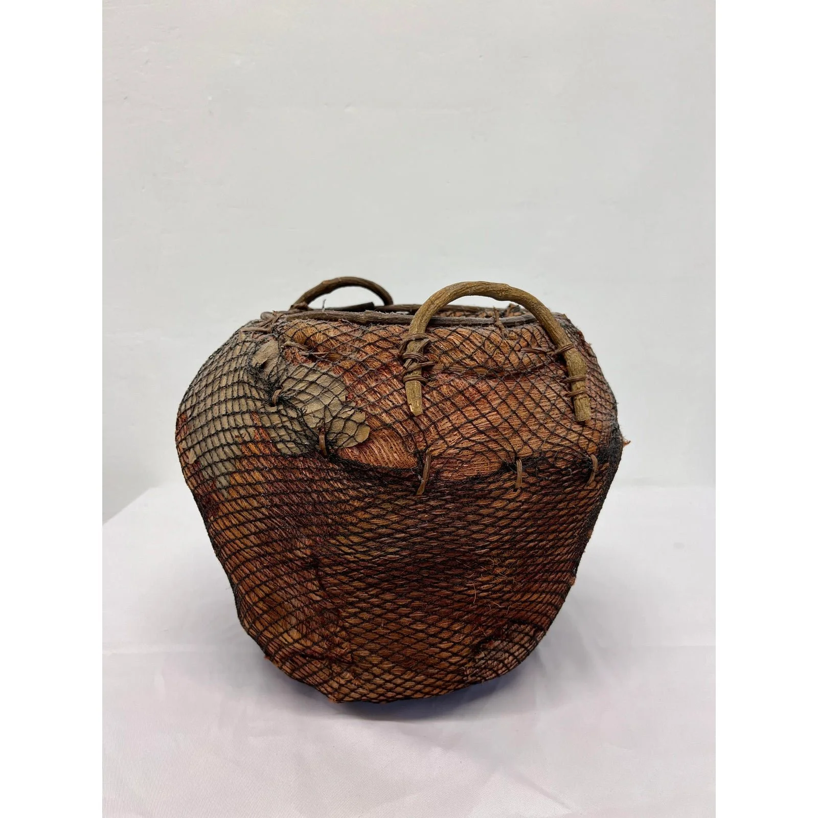 handmade-natural-fiber-and-leaf-basket-wrapped-in-fish-net-1970s-5653