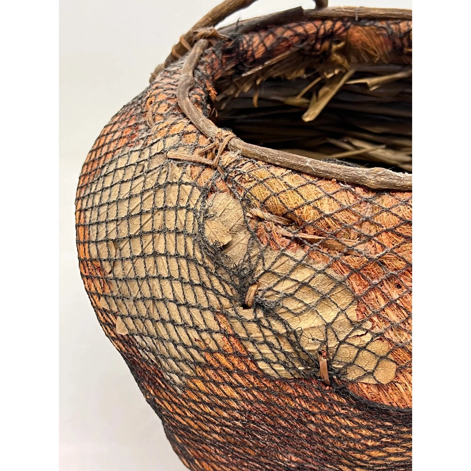 handmade-natural-fiber-and-leaf-basket-wrapped-in-fish-net-1970s-2389
