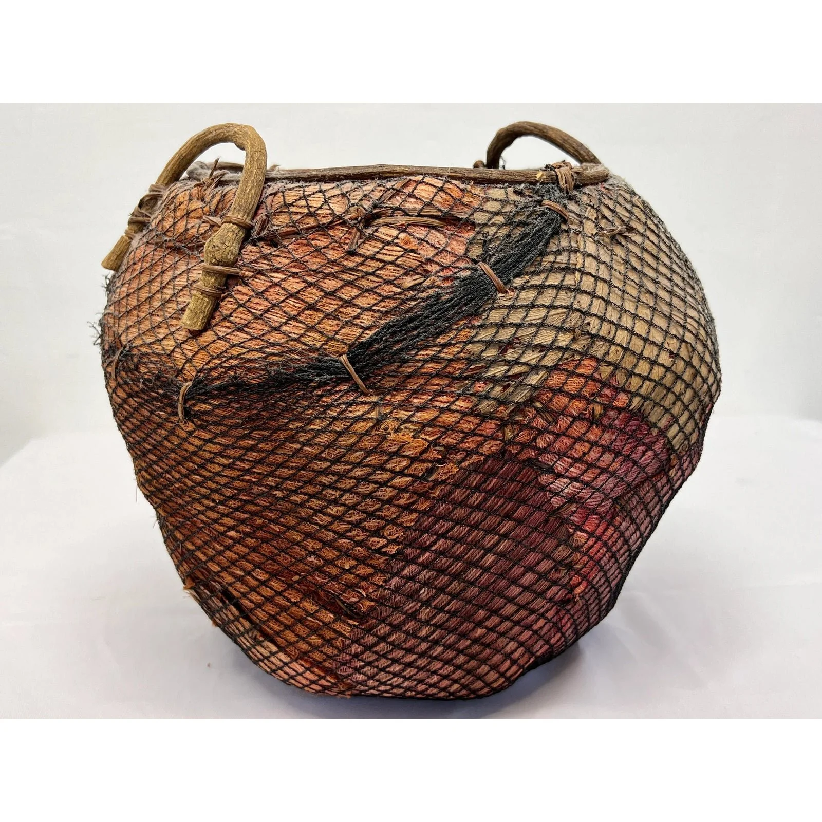 handmade-natural-fiber-and-leaf-basket-wrapped-in-fish-net-1970