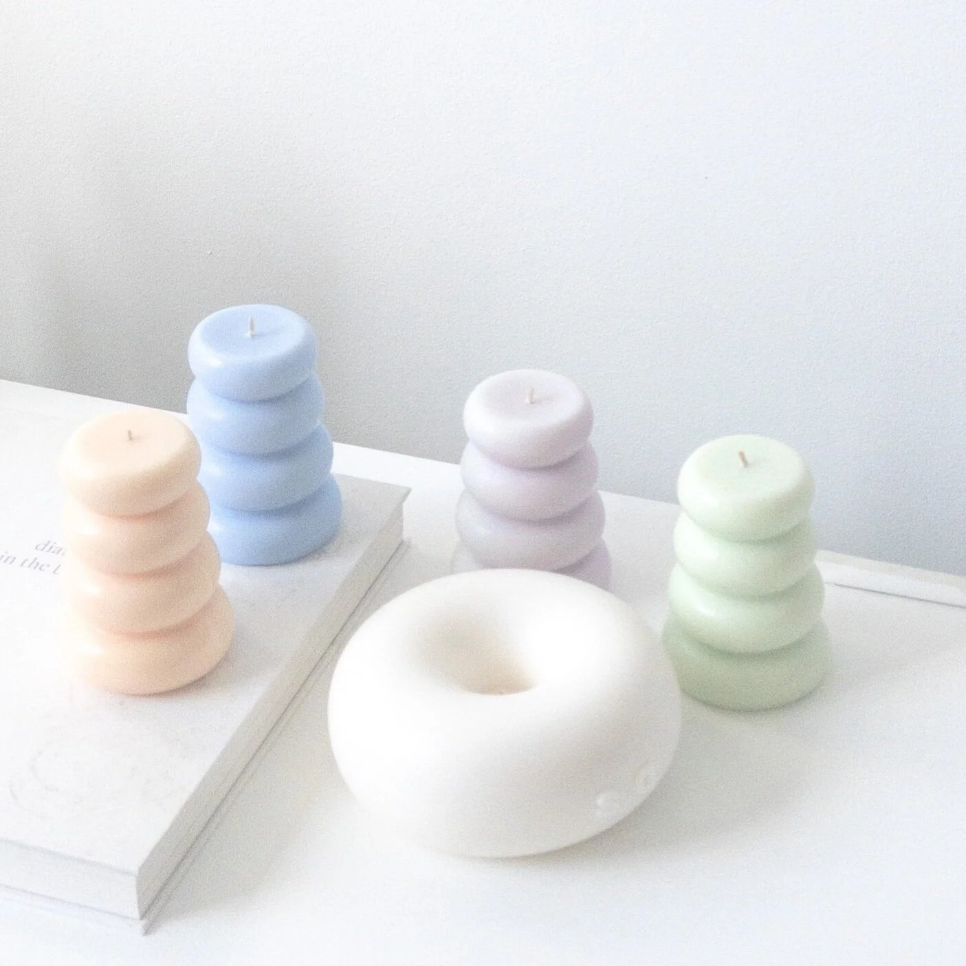 Artistic donut candles with unique designs Handmade artisan candles inspired by donuts