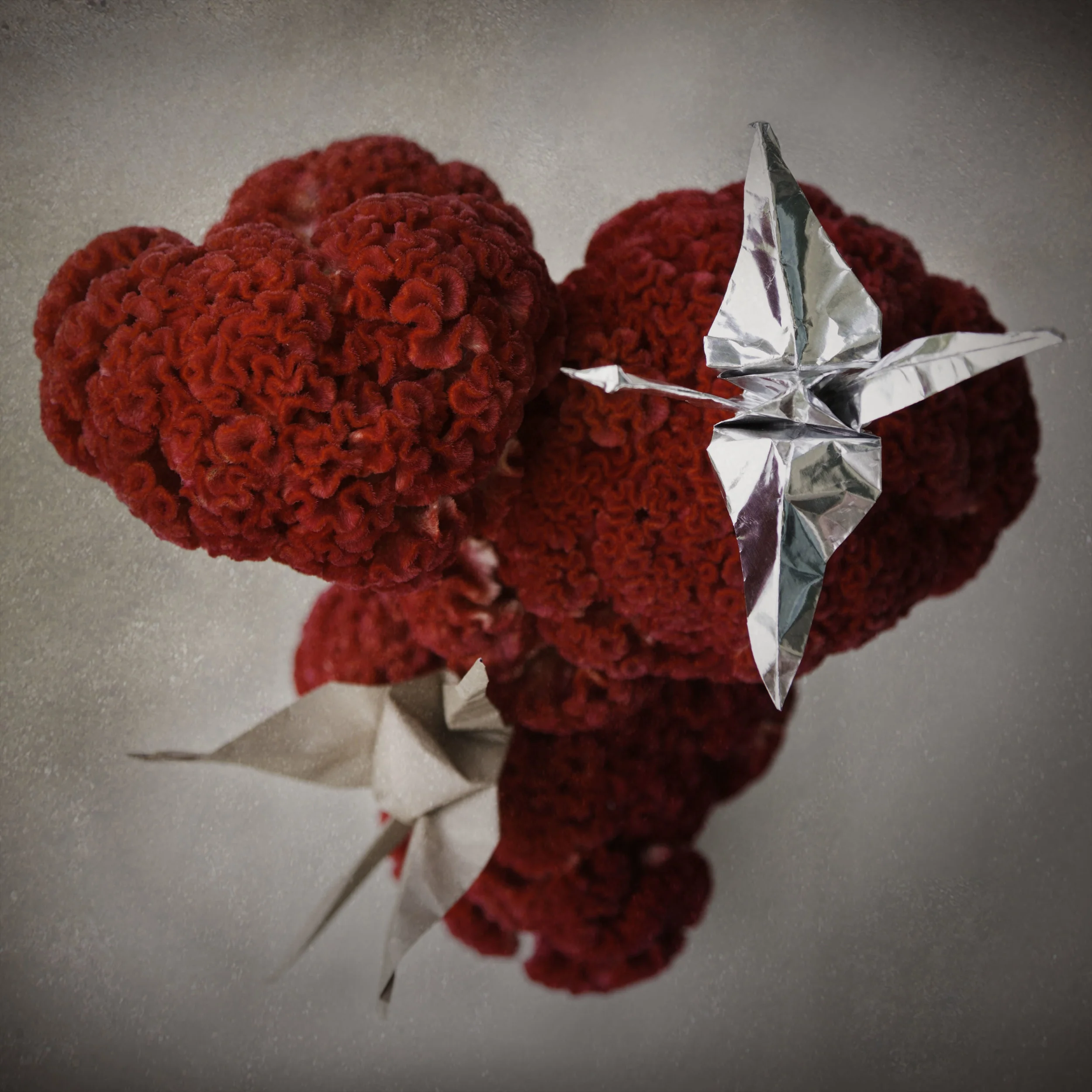 Handmade crane props made from traditional origami foiled and brown paper.