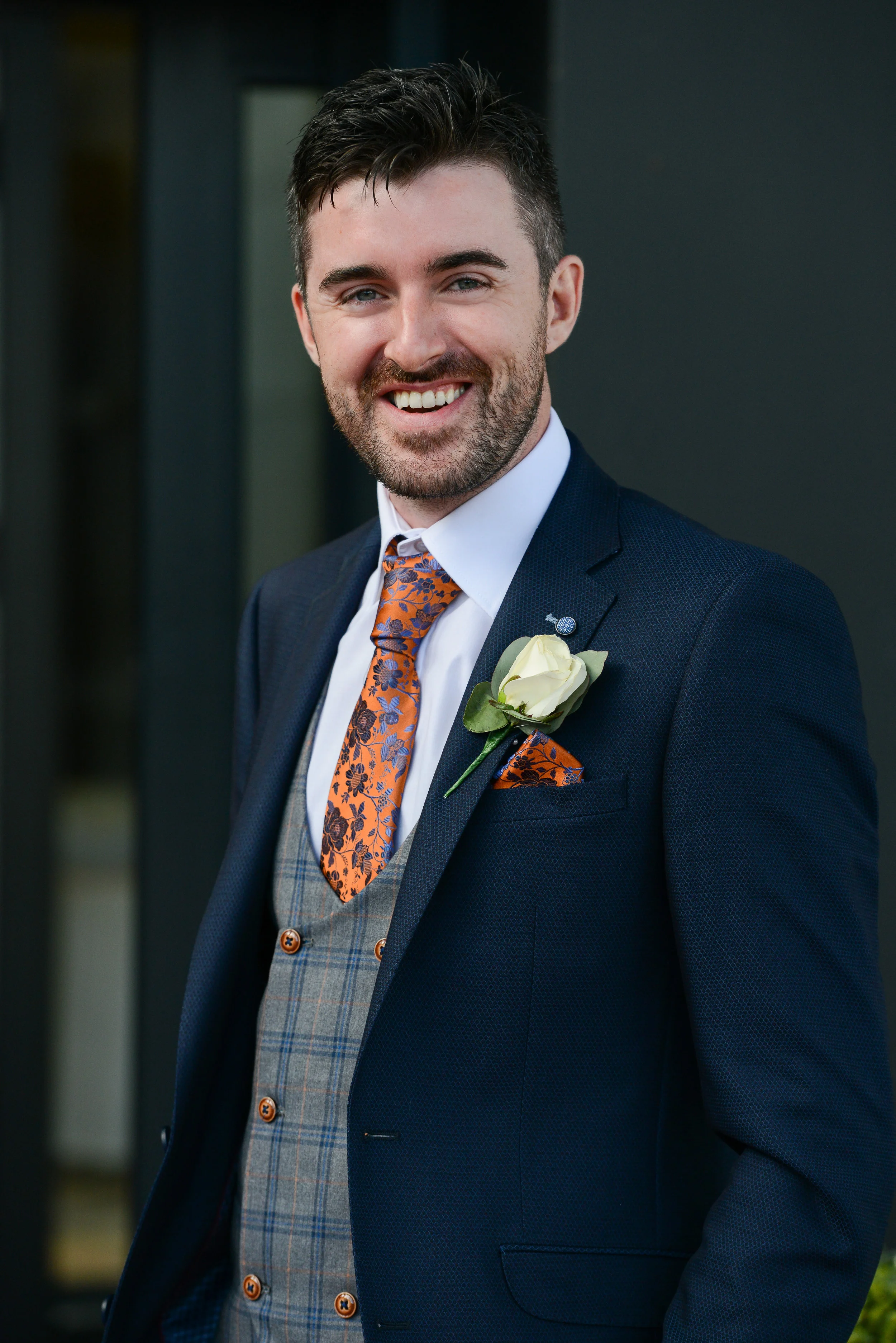 groom lee looking handsome with this quirky navy blue suit with orange floral tie , supplied by Statement Mens Wear (Portadown