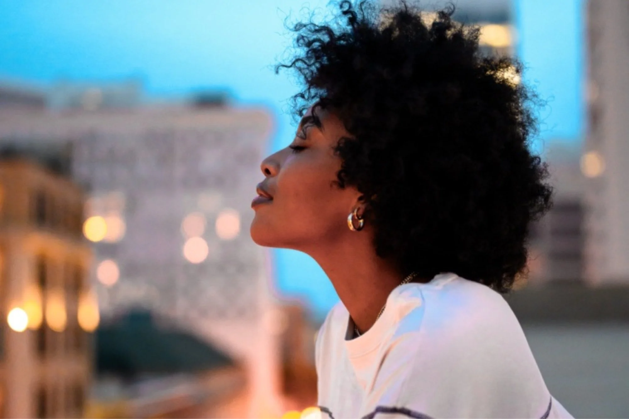 Woman in a city balcony doing mindfulness