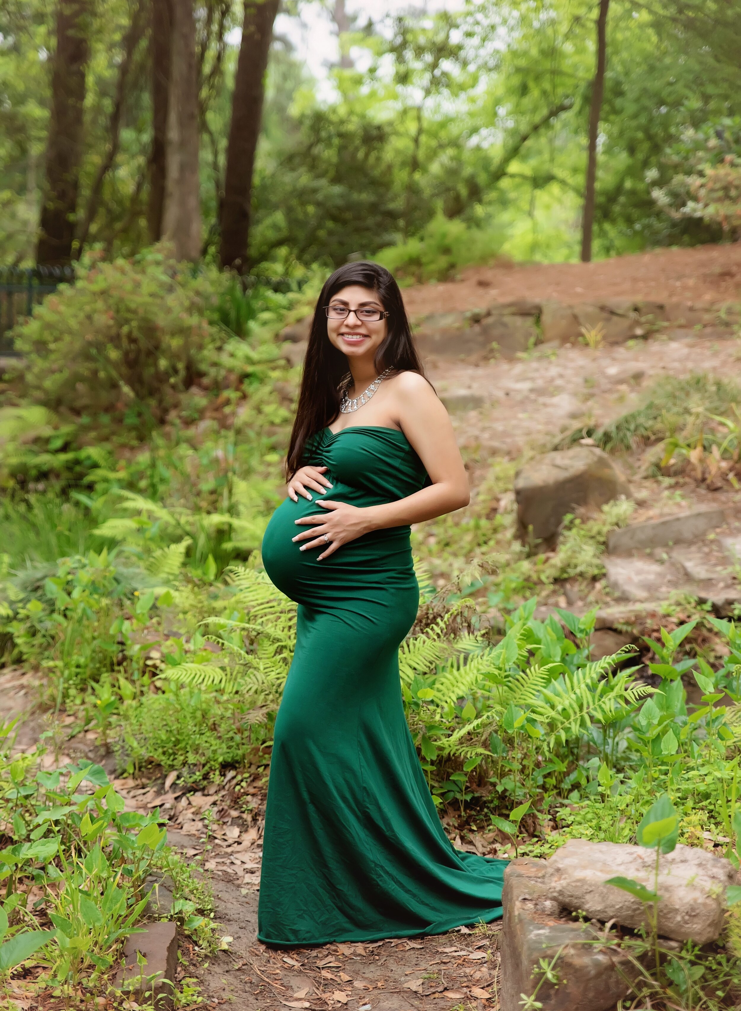 Pregnant mom in green gown at Mercer Botanic Gardens in Houston. 