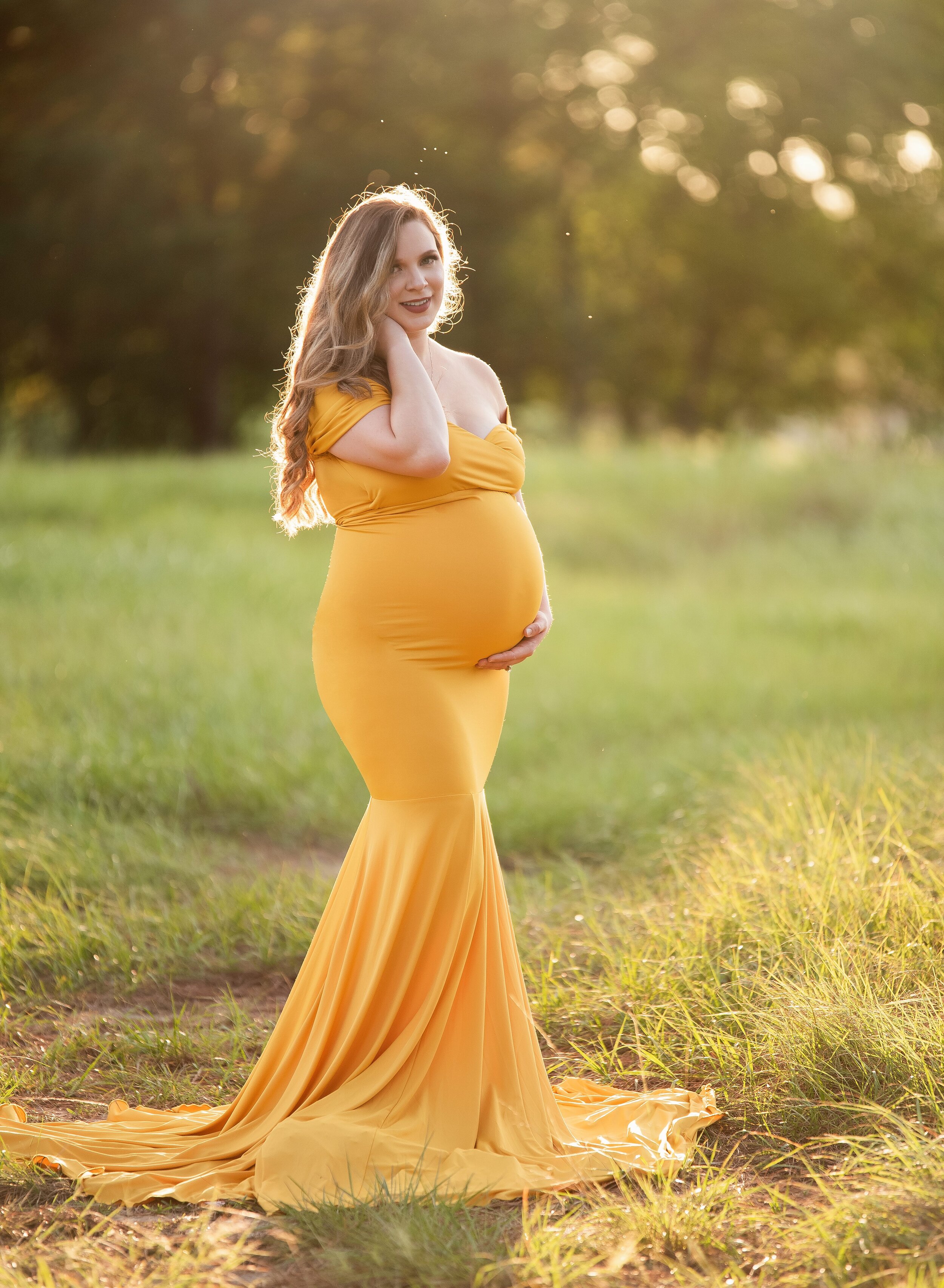 Pregnant mom in yellow gown outside in Crosby, TX