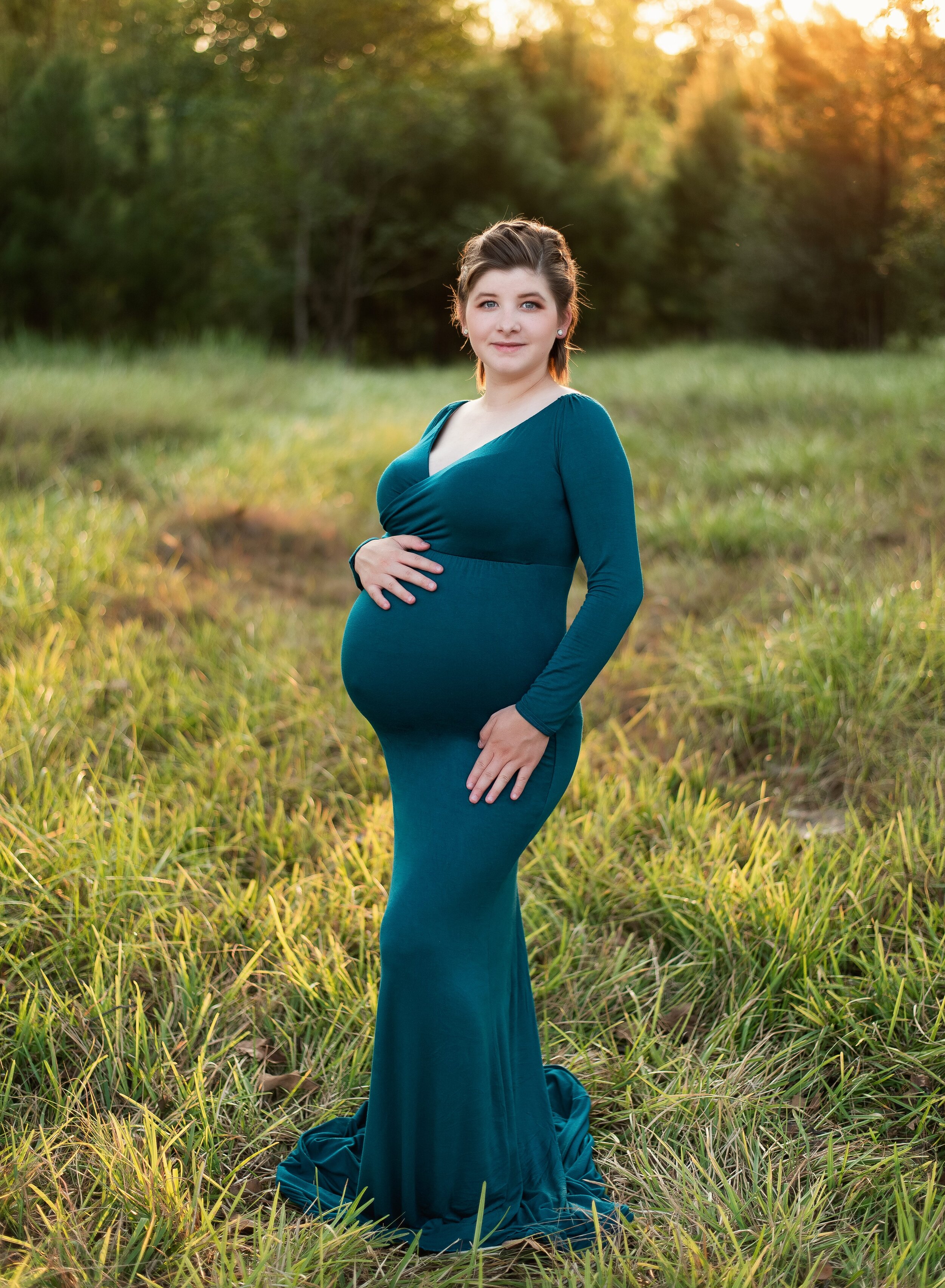Young pregnant mom in teal gown outside in Crosby, TX