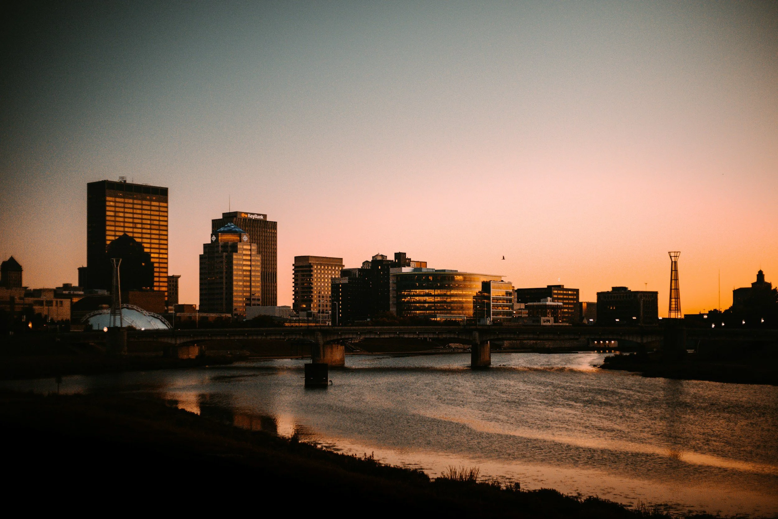 Downtown Dayton, OH skyline at sunset along the Great Miami River