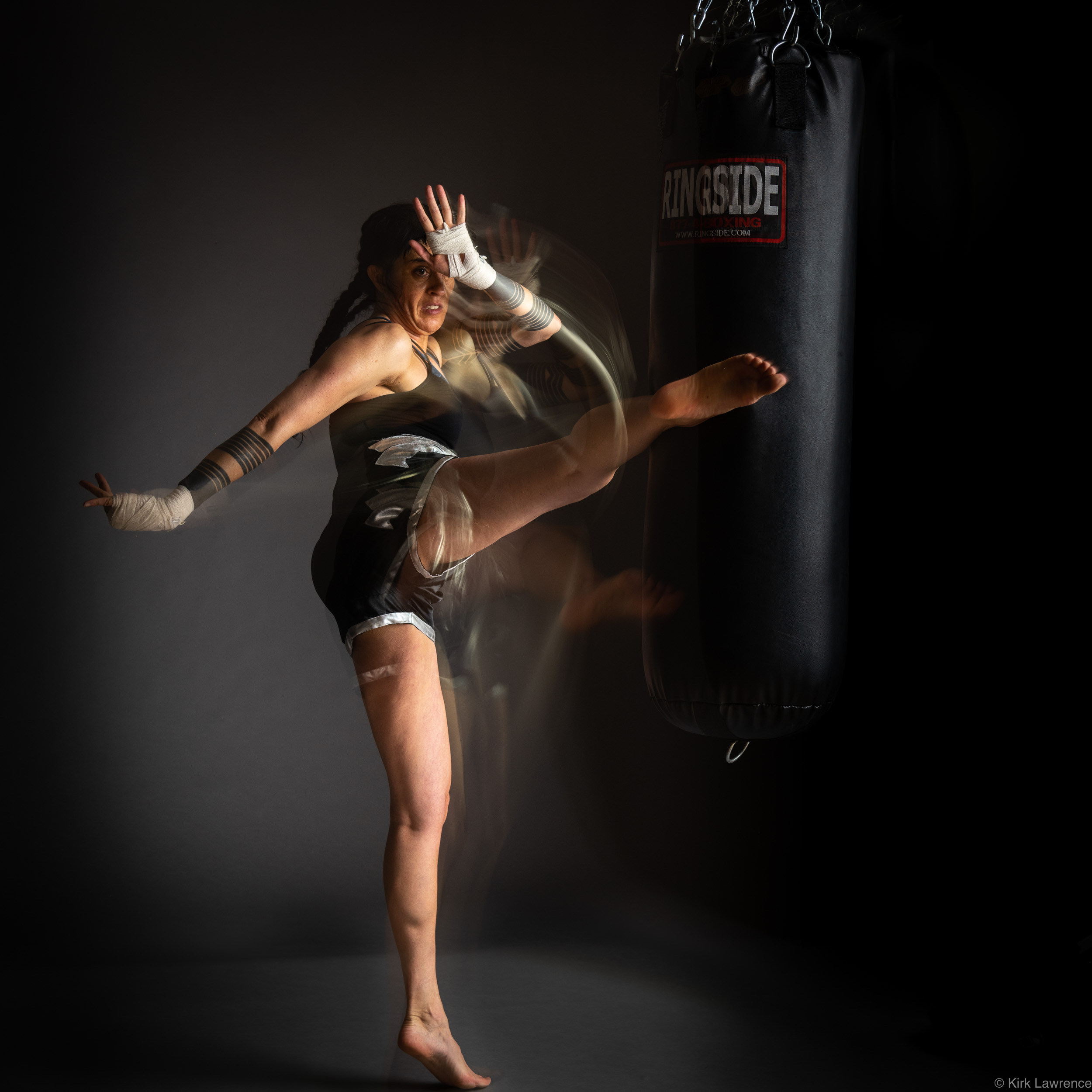 female_kickboxer_kicking_bag.jpg