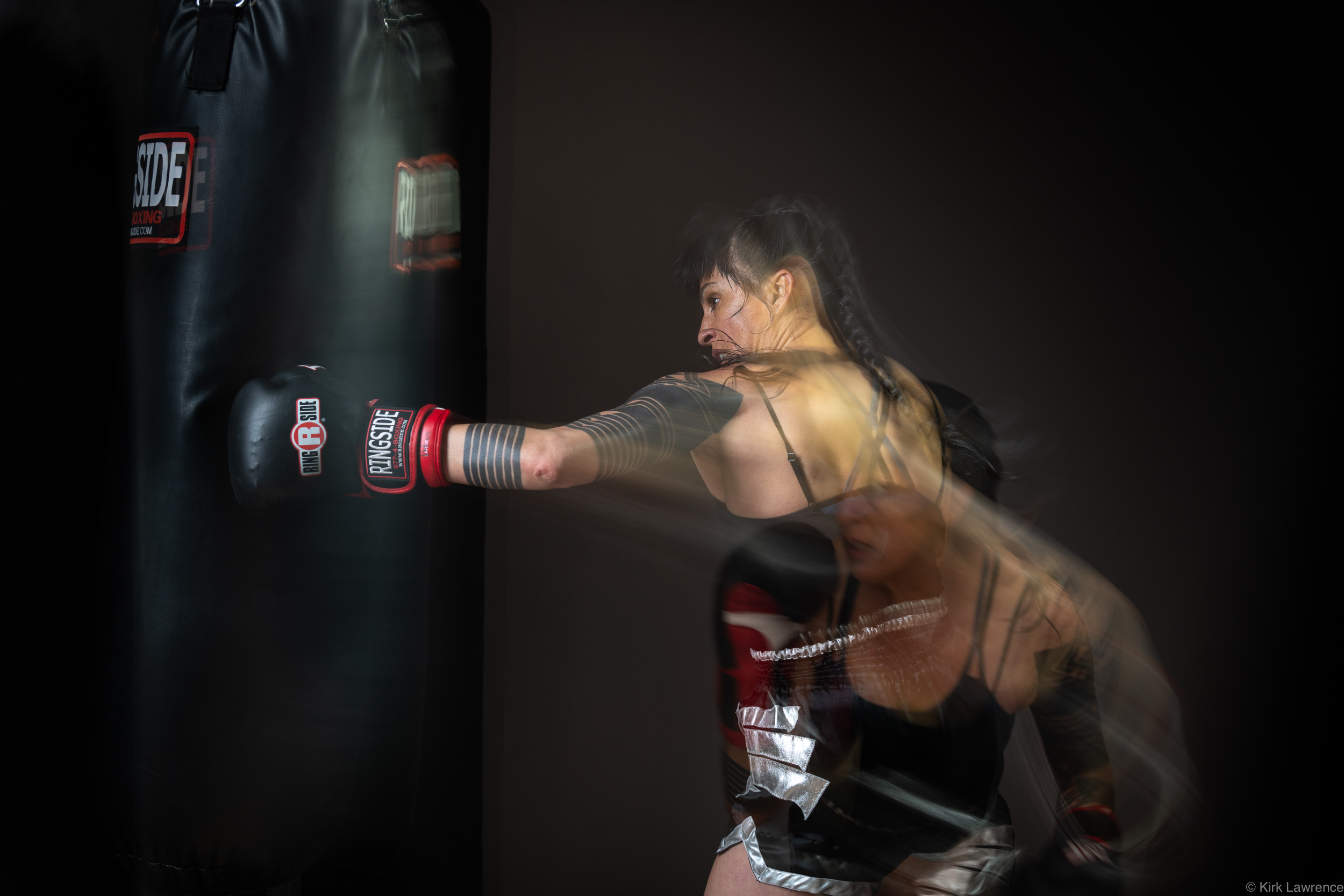 female_kickboxer_punching_bag.jpg