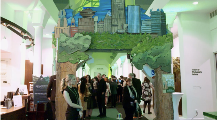 Upcycled cardboard art (6 total environmental and Rochester themed arches) from Rochester's own Magnus Apollo Design were on display at the Fast Forward Film Festival Green-Carpet Gala in 2018 held annually at the George Eastman Museum. This event features zero/minimal waste kiosks from Impact Earth and helps teach guests composting, recycling, and landfill education.