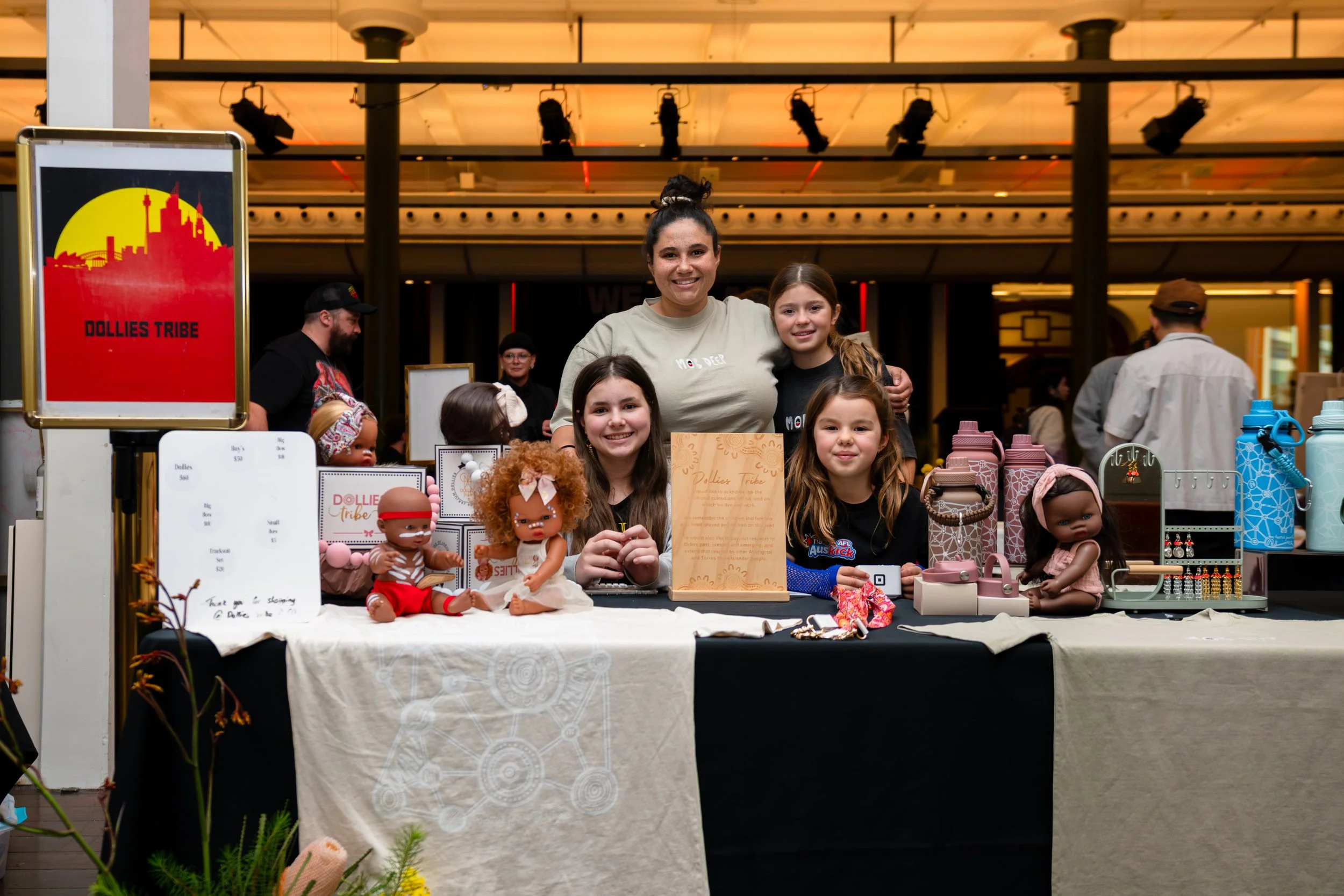 Group portrait of Aboriginal family at indoor event