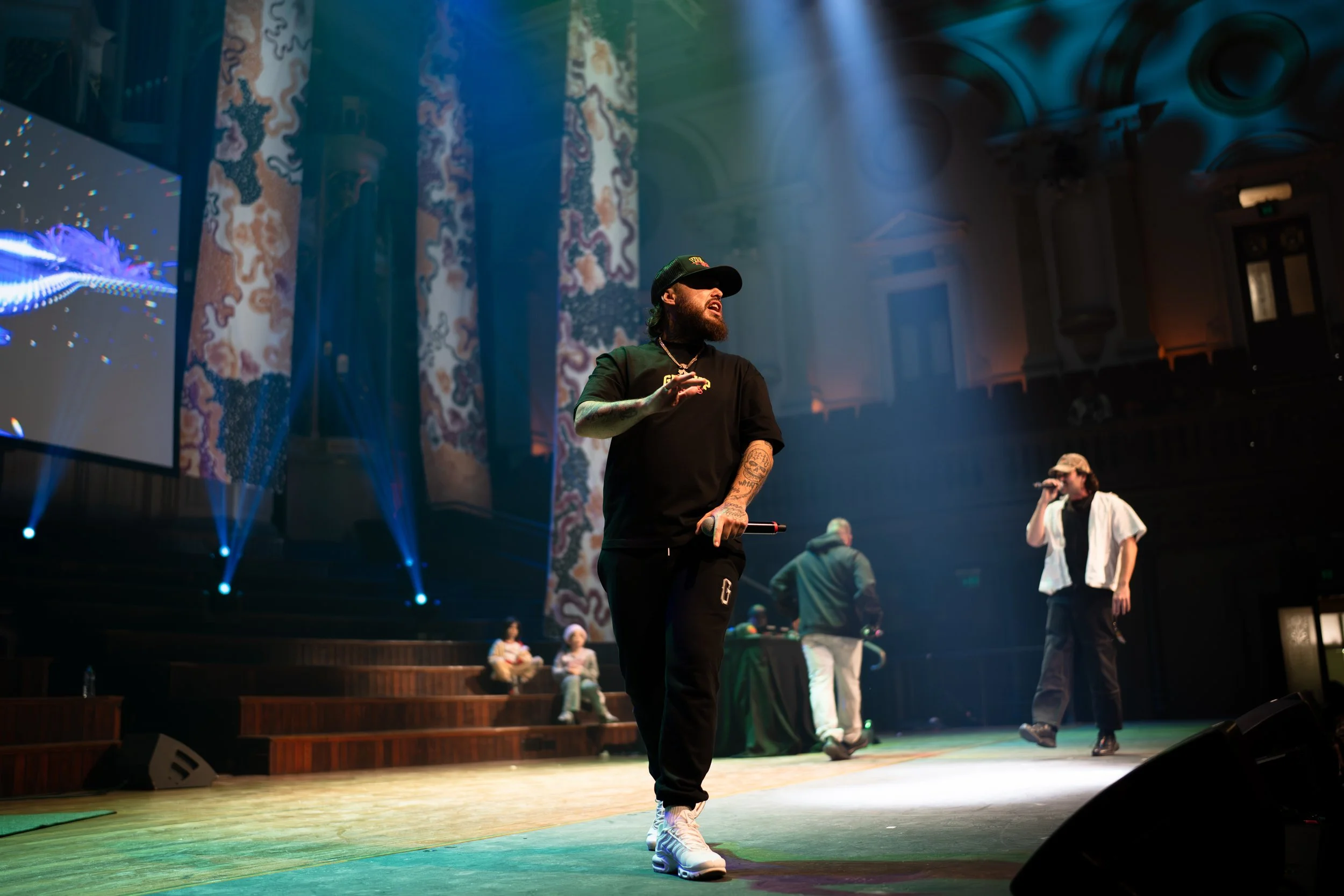 Candid photograph of Aboriginal man performing on stage